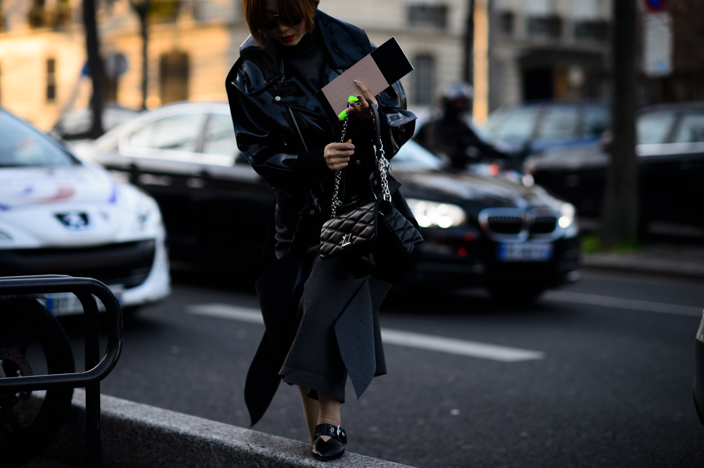 Woman wearing all black crosses road