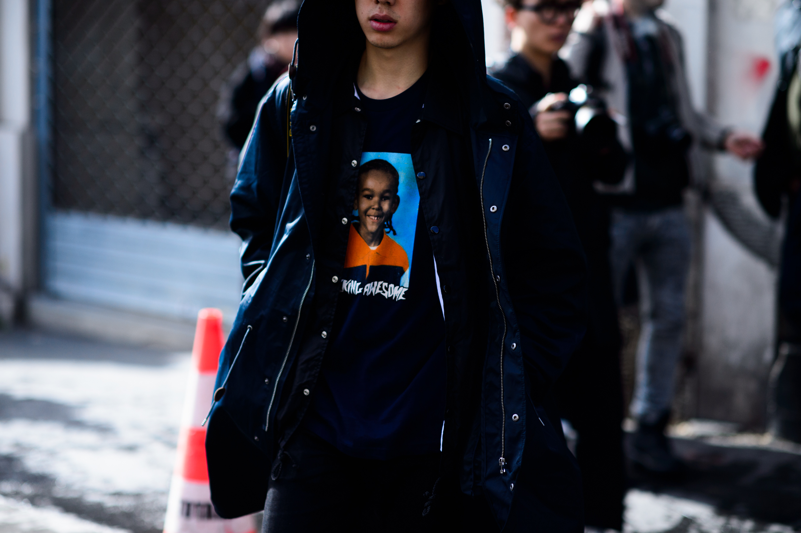Man wearing graphic tee shirt and raincoat