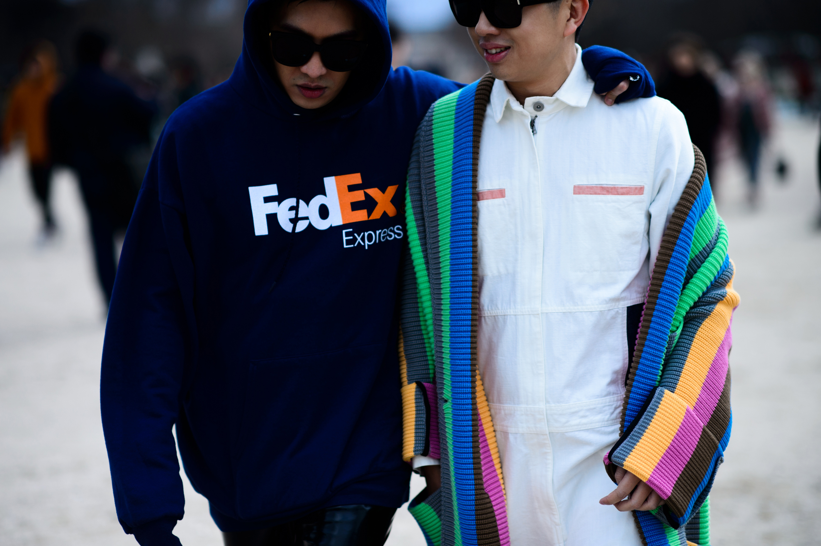 Two men walking wearing sunglasses