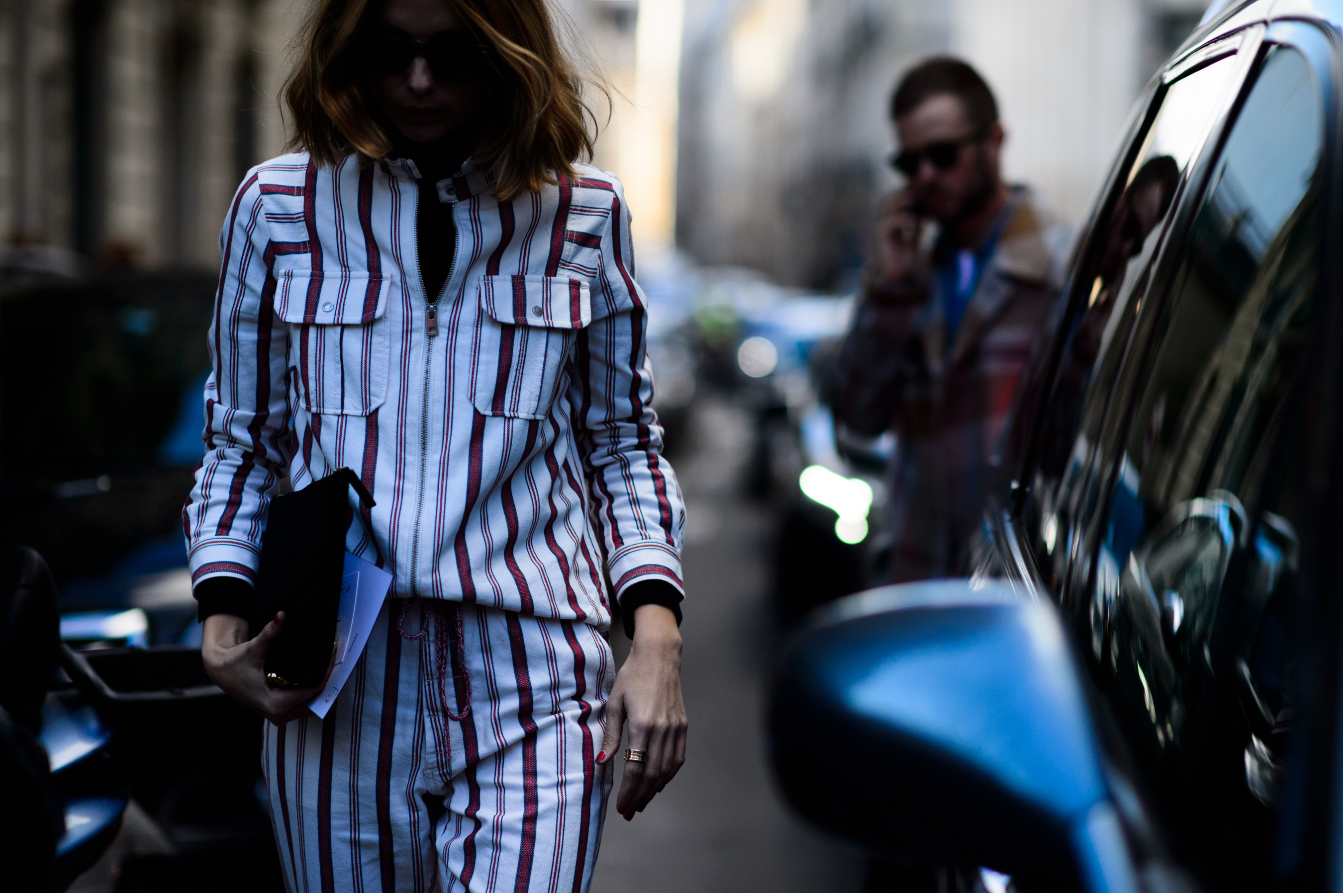 Woman by car wearing red and white striped outfit