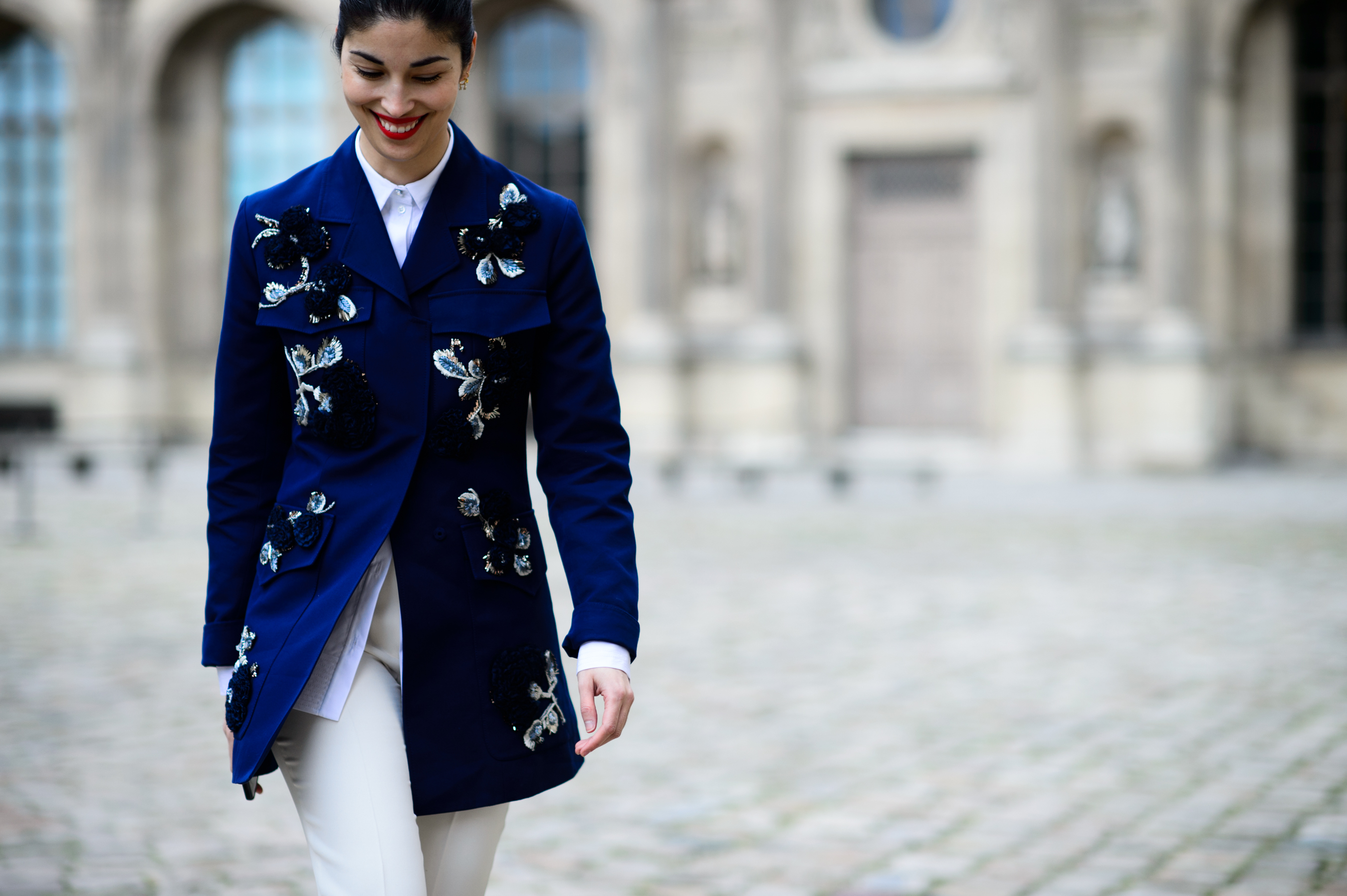 Woman smiling wearing blue floral jacket