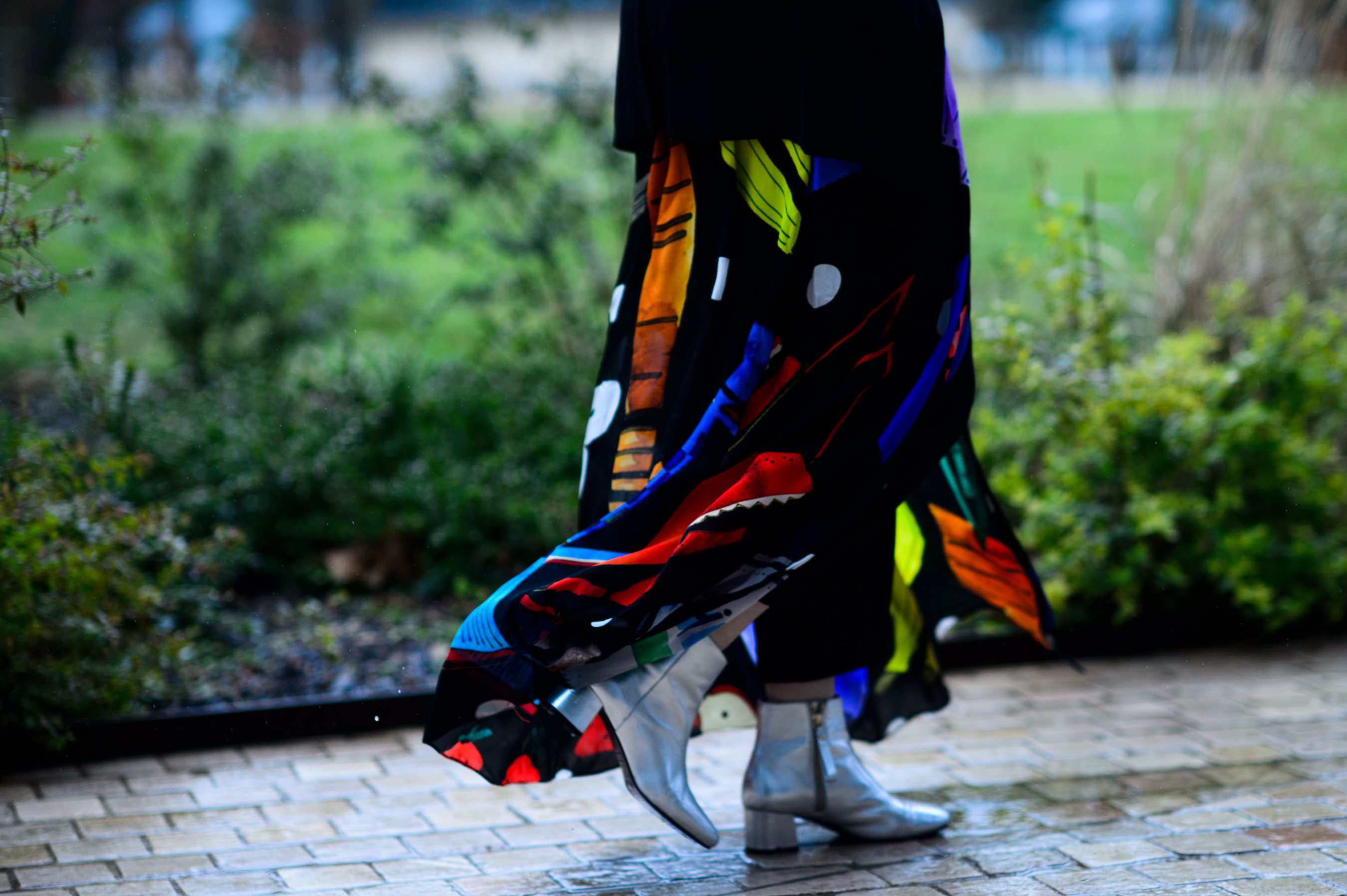 Closeup of woman walking in silver boots