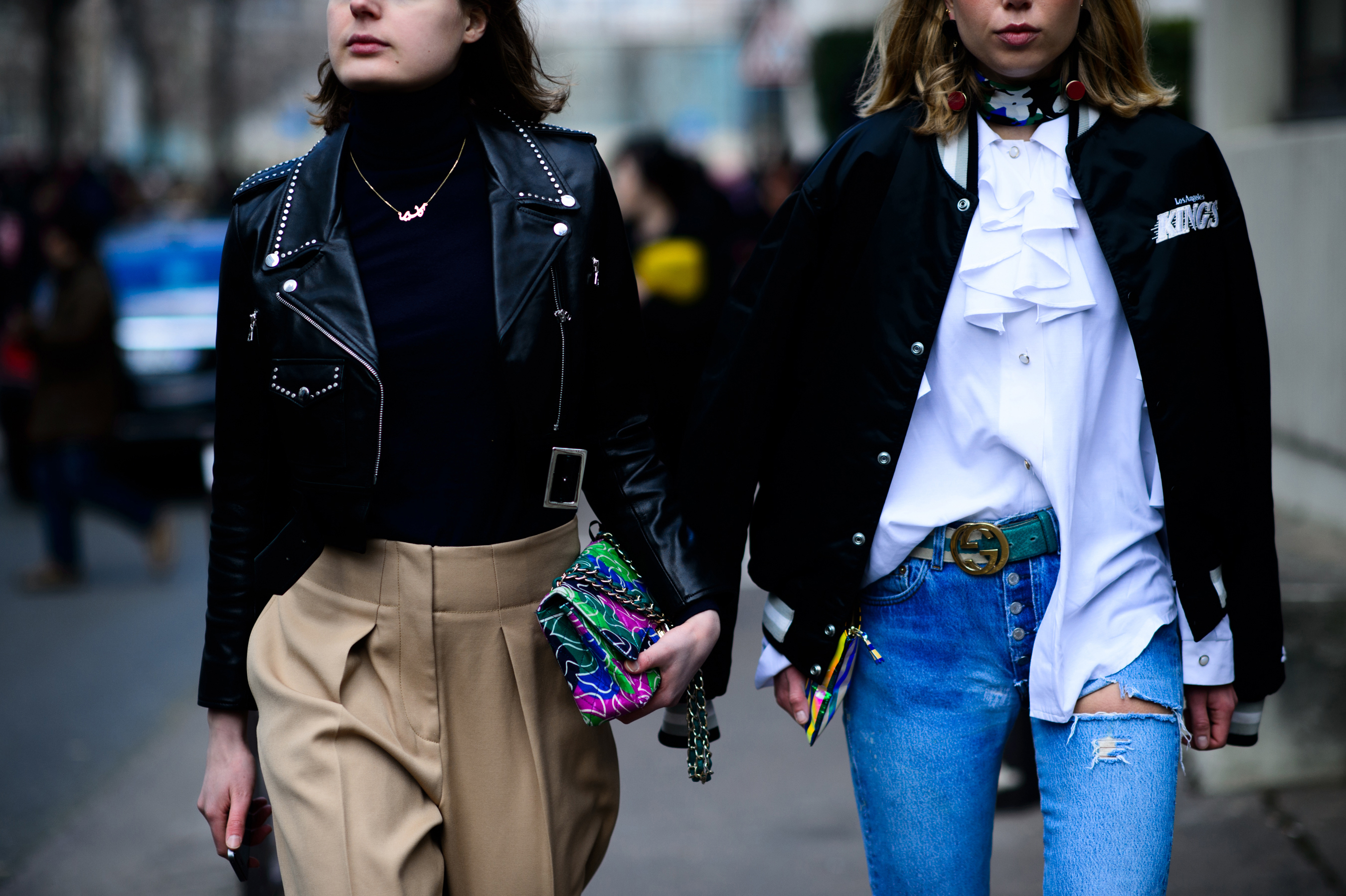 Two women walking with multicoloured purses