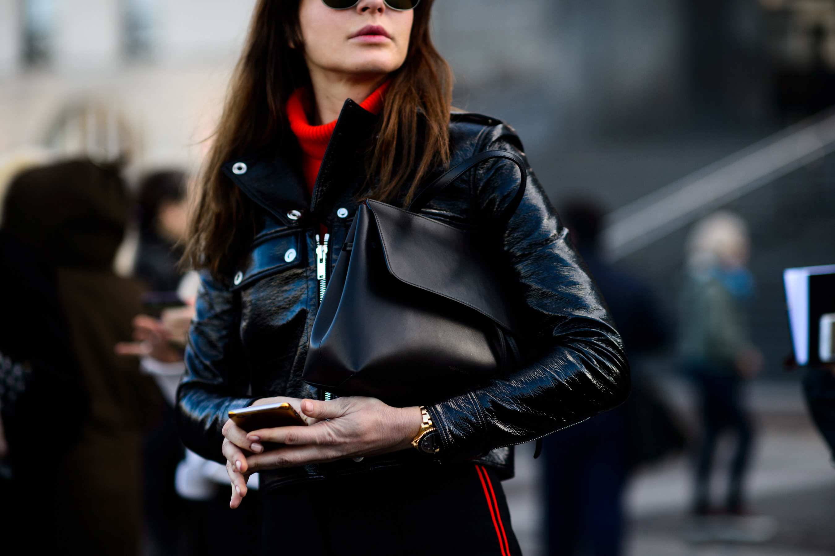 Woman with black leather bag under arm