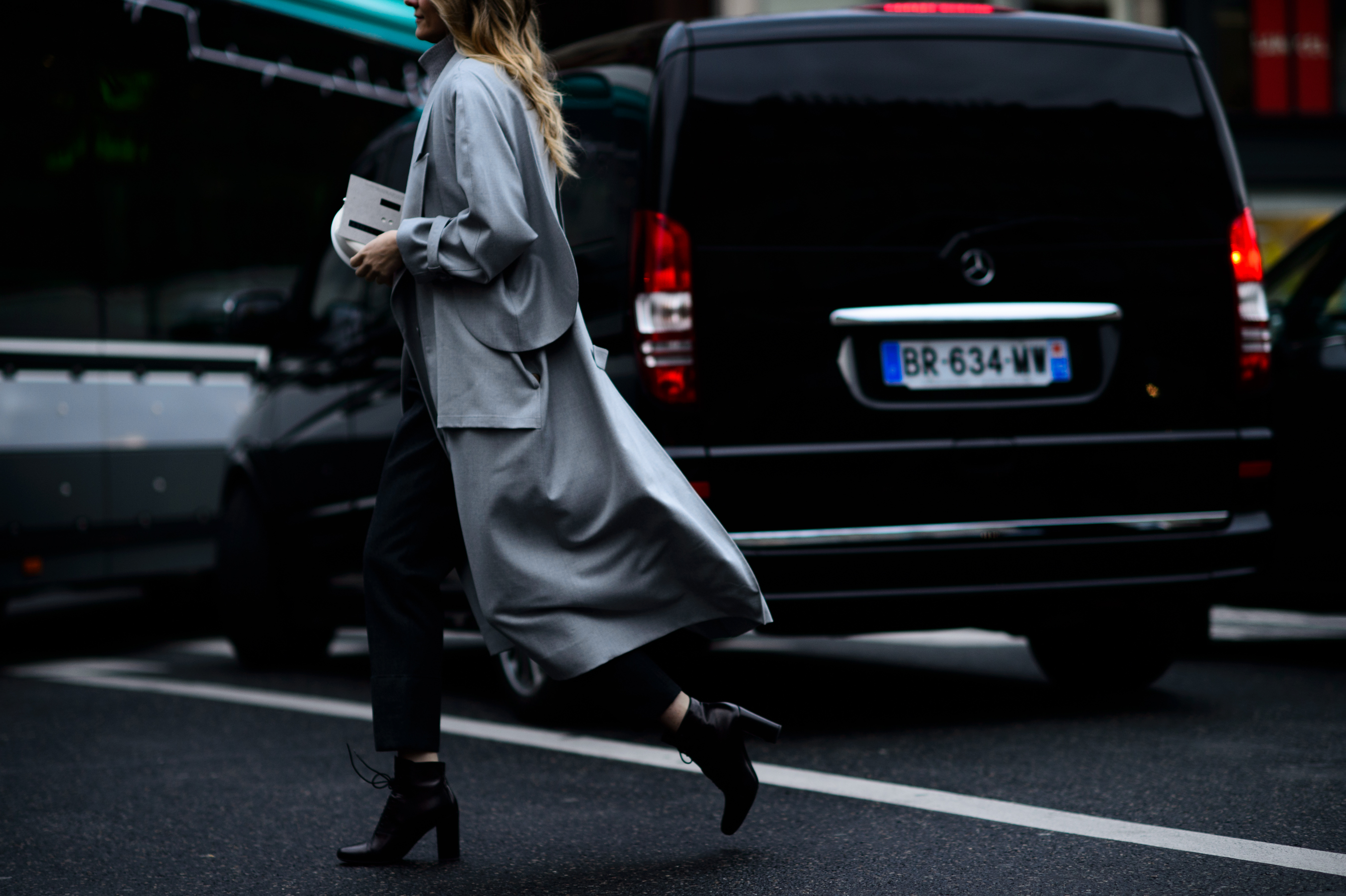 Stylist walking in long grey coat