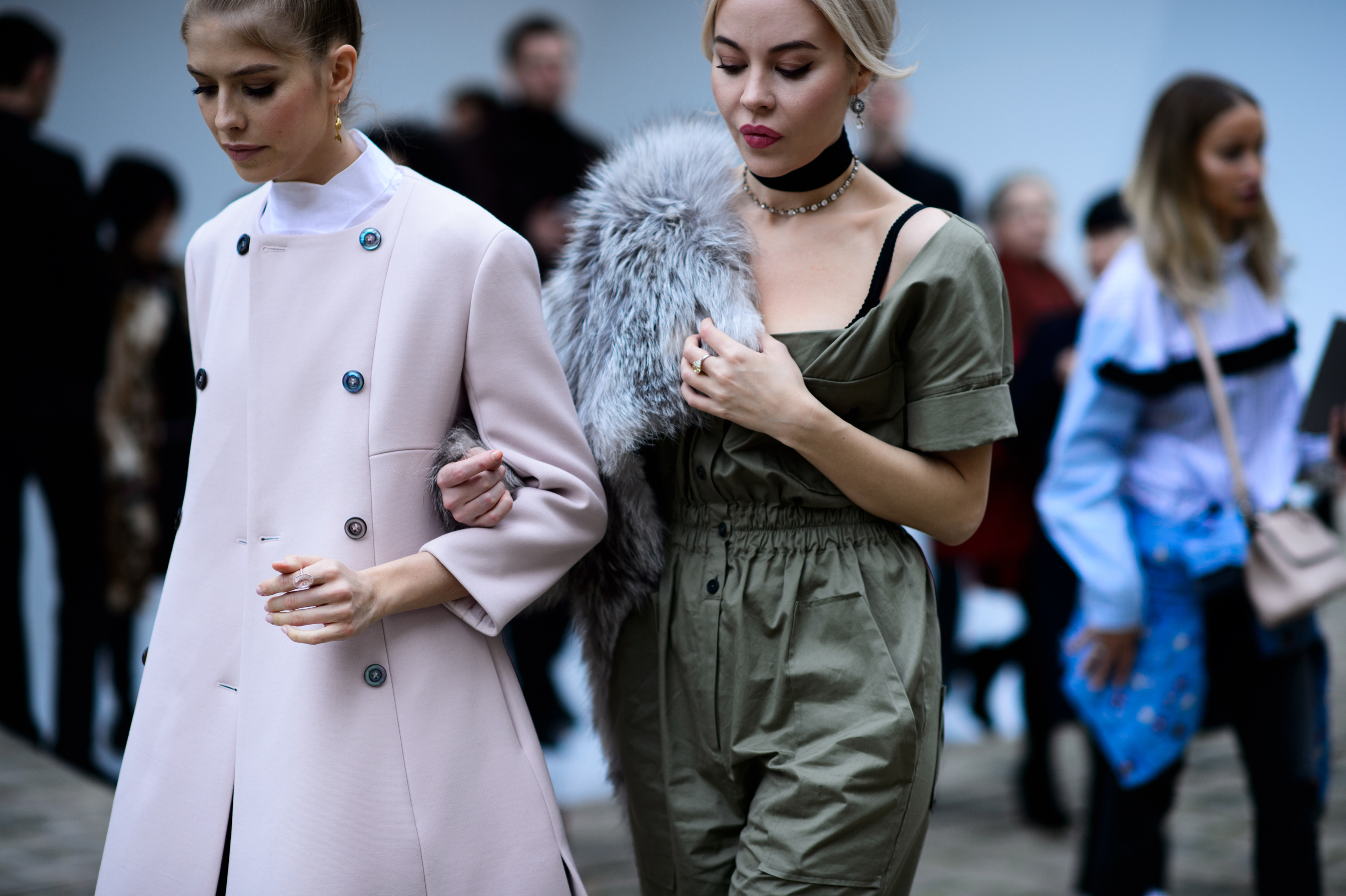 Two women walking with linked arms