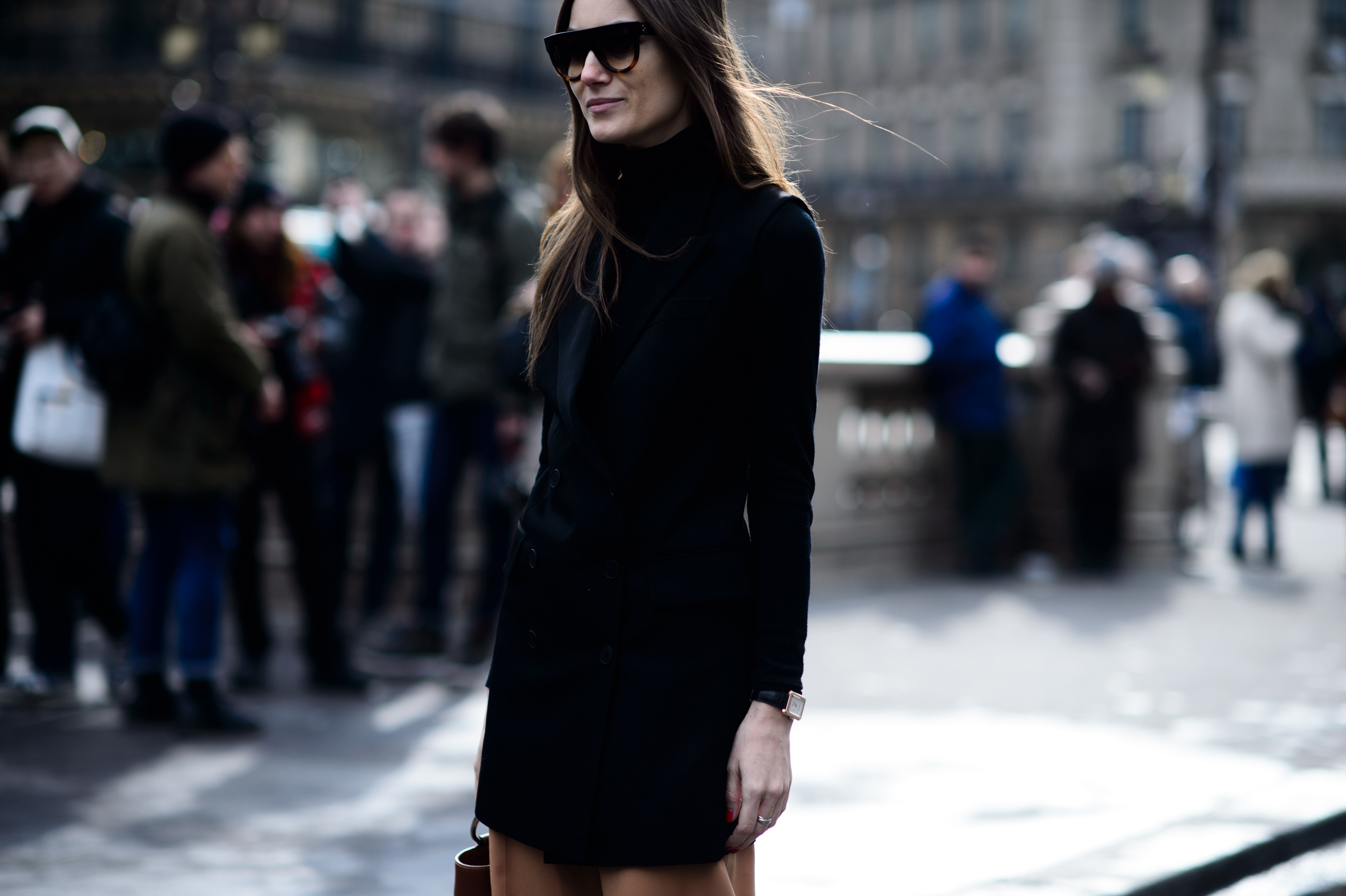 Woman in dark sunglasses and dark dress
