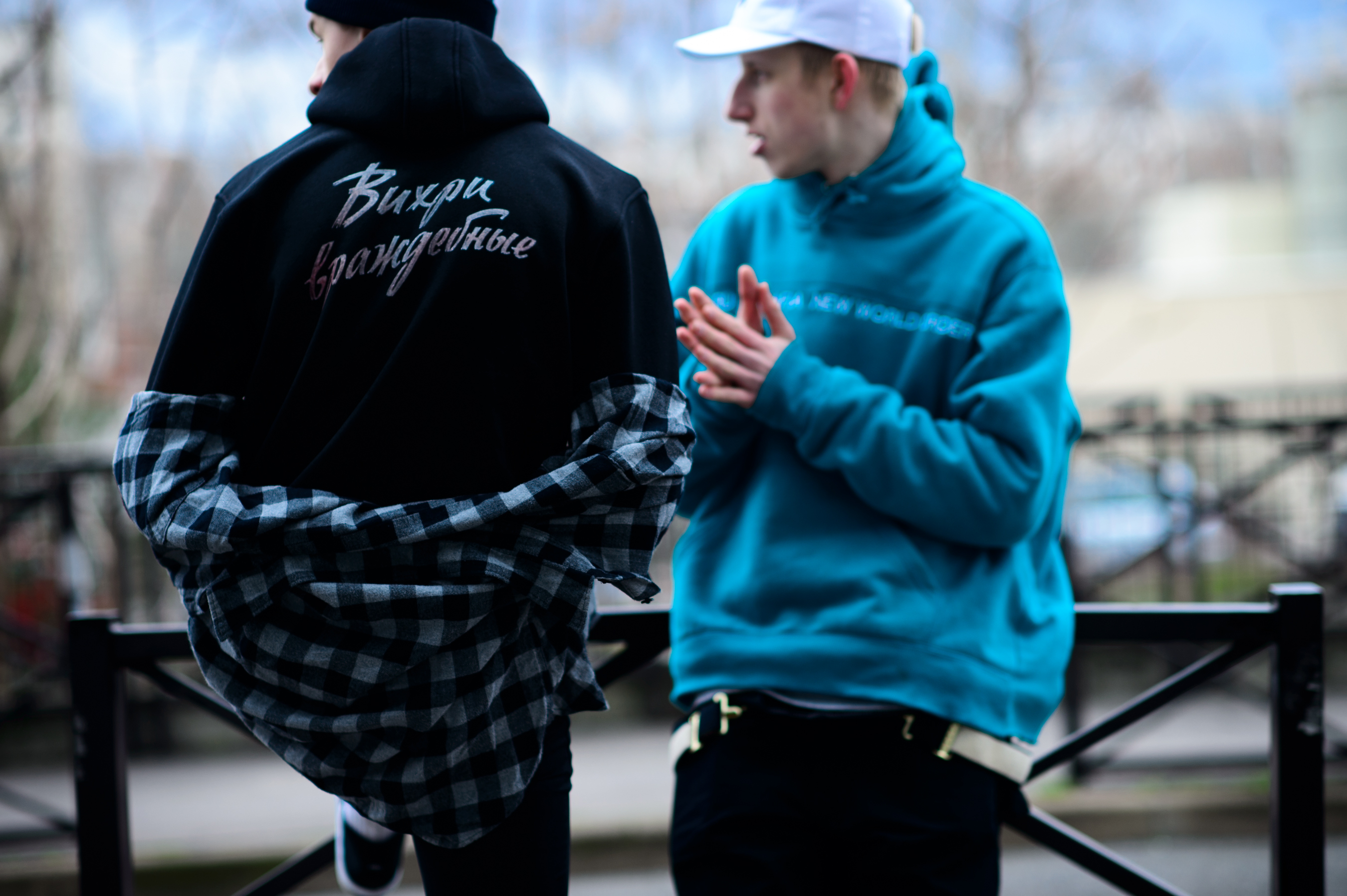 Two men wearing graphic print hoodies