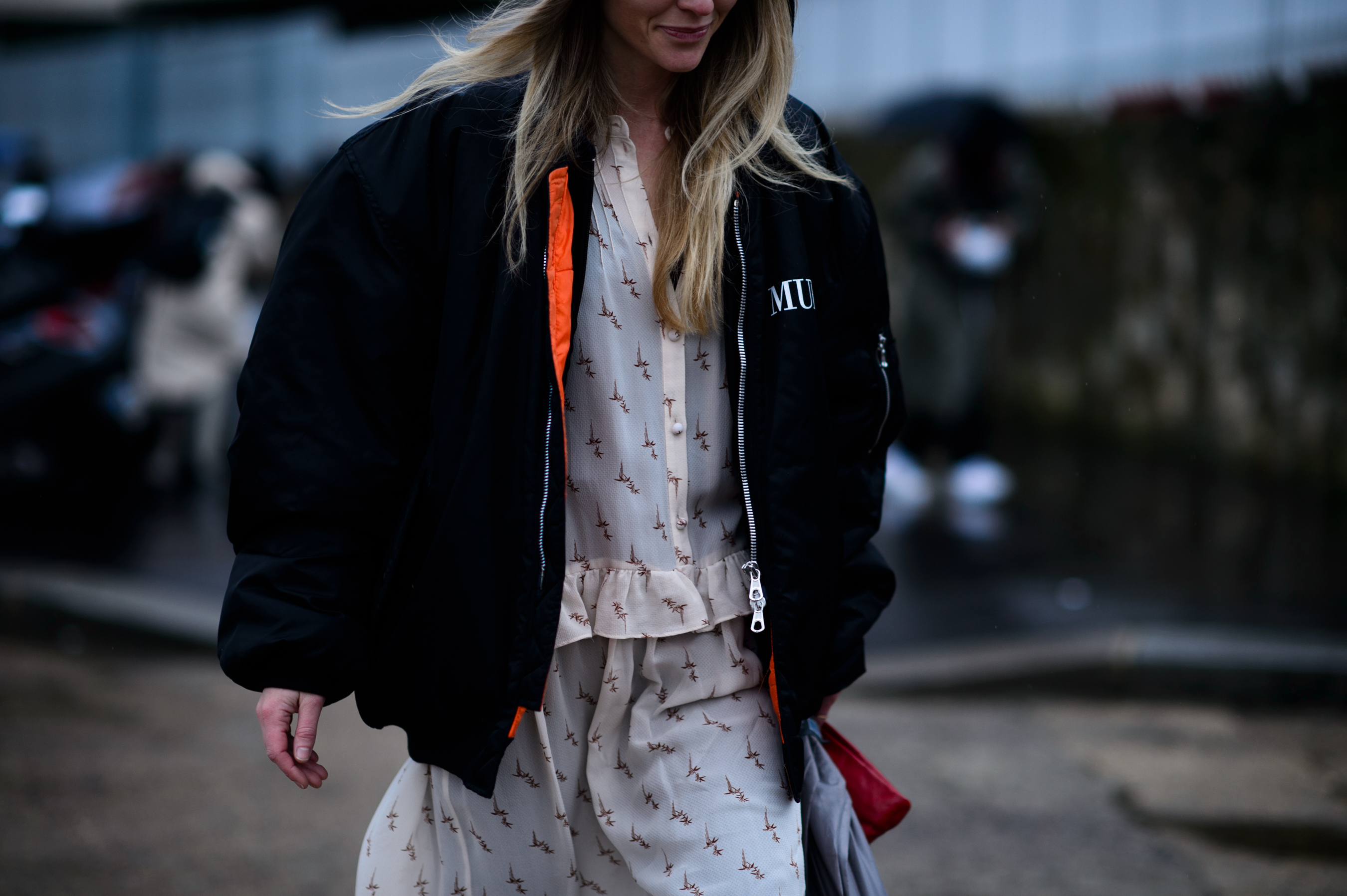 Woman in black bomber with orange details