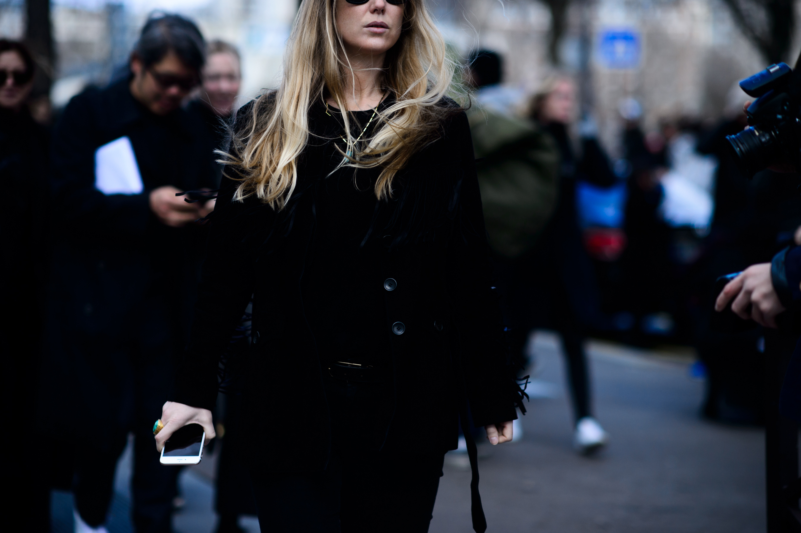 Woman with long blonde hair wearing black outfit