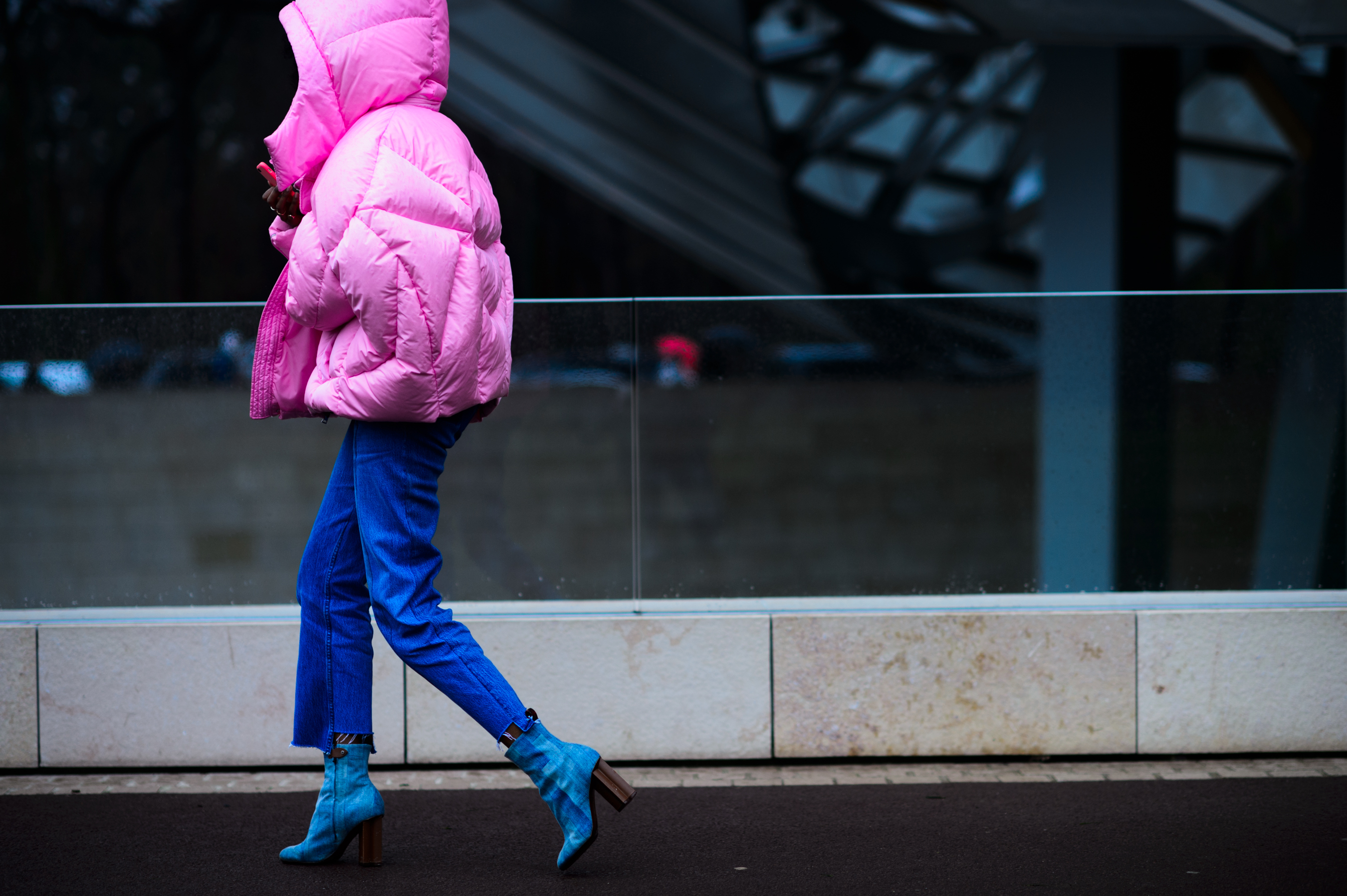 Woman wearing bright pink coat with hood