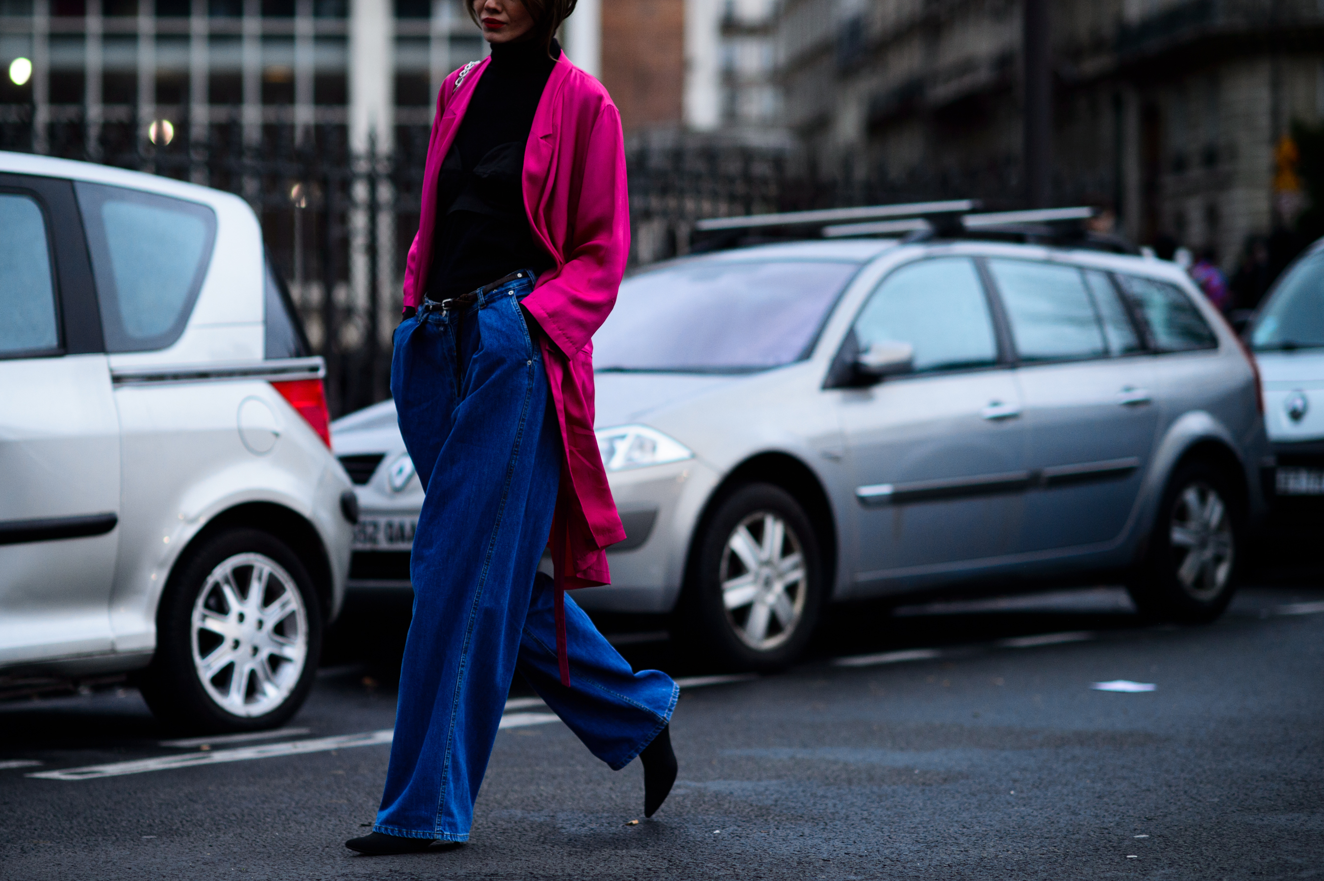 Woman wearing pink coat over black turtleneck
