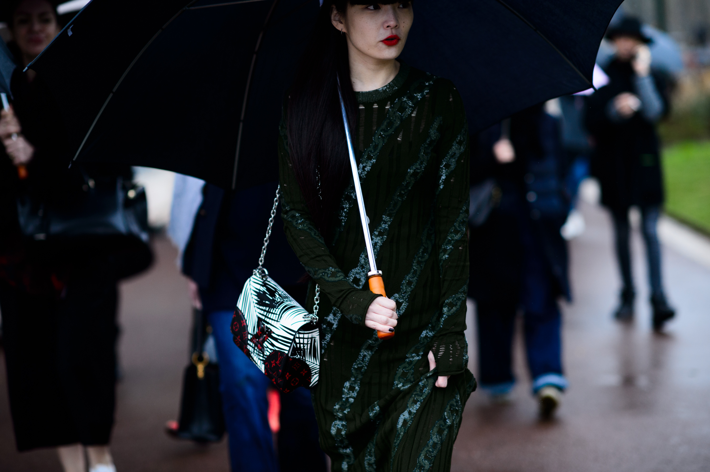 Model under umbrella in green dress
