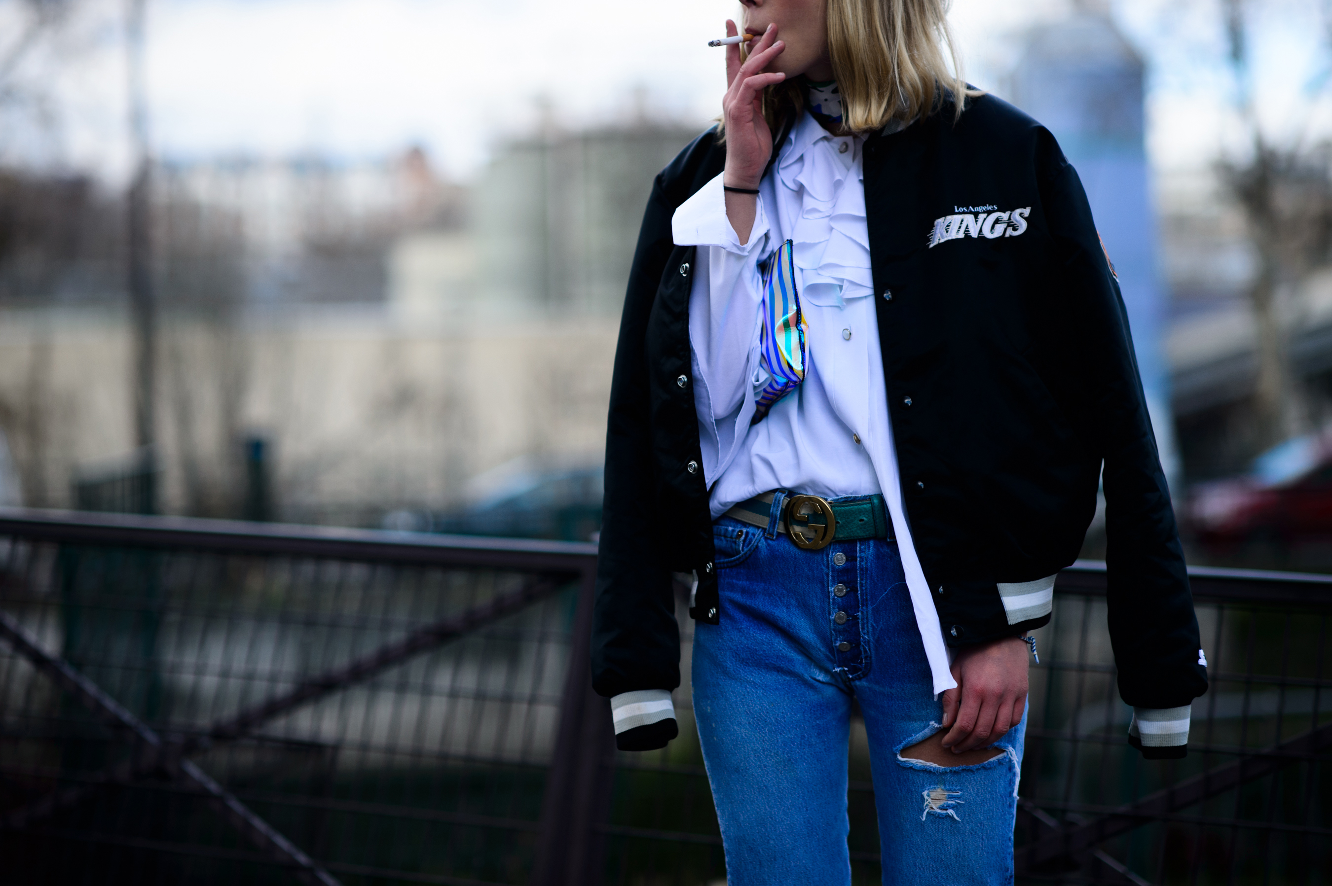 Woman smoking in black hockey jacket