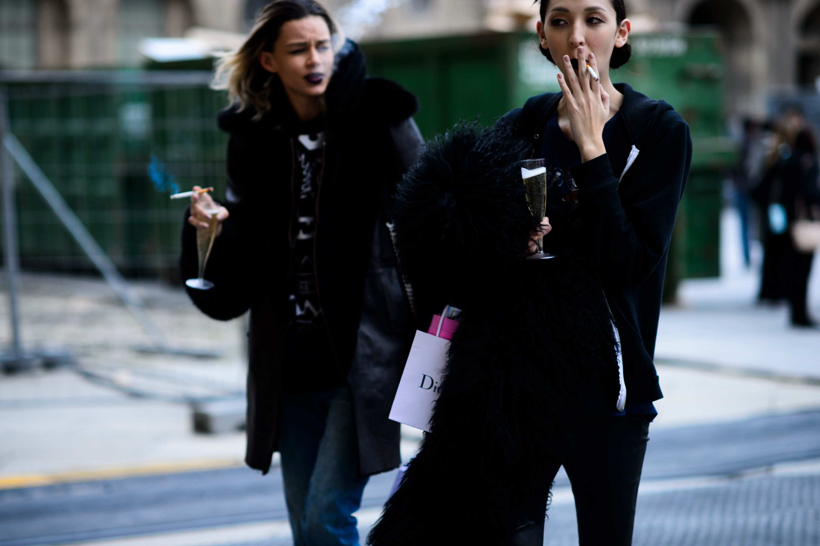 Models smoking with champagne after show