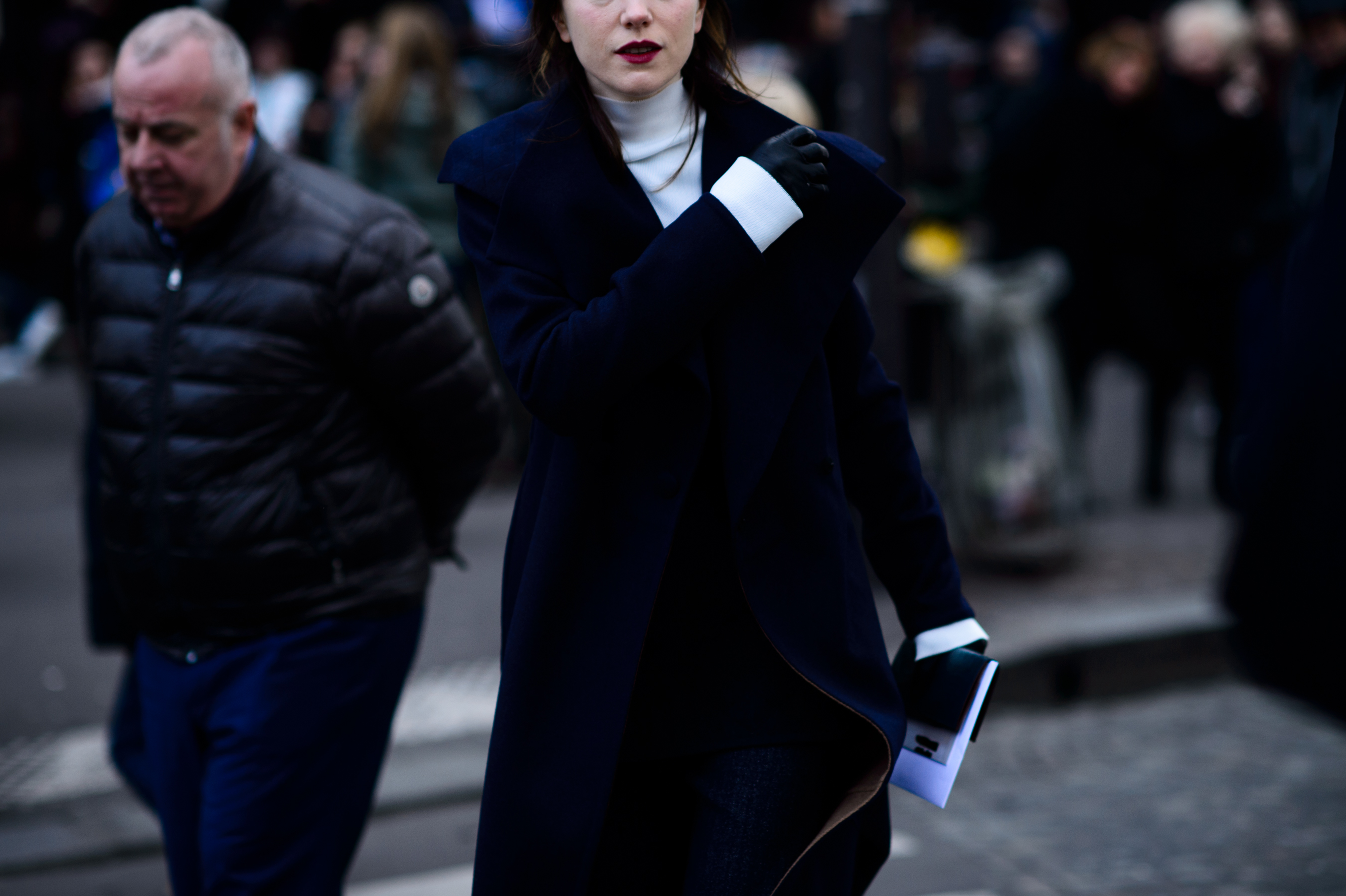 Woman with navy coat and black gloves