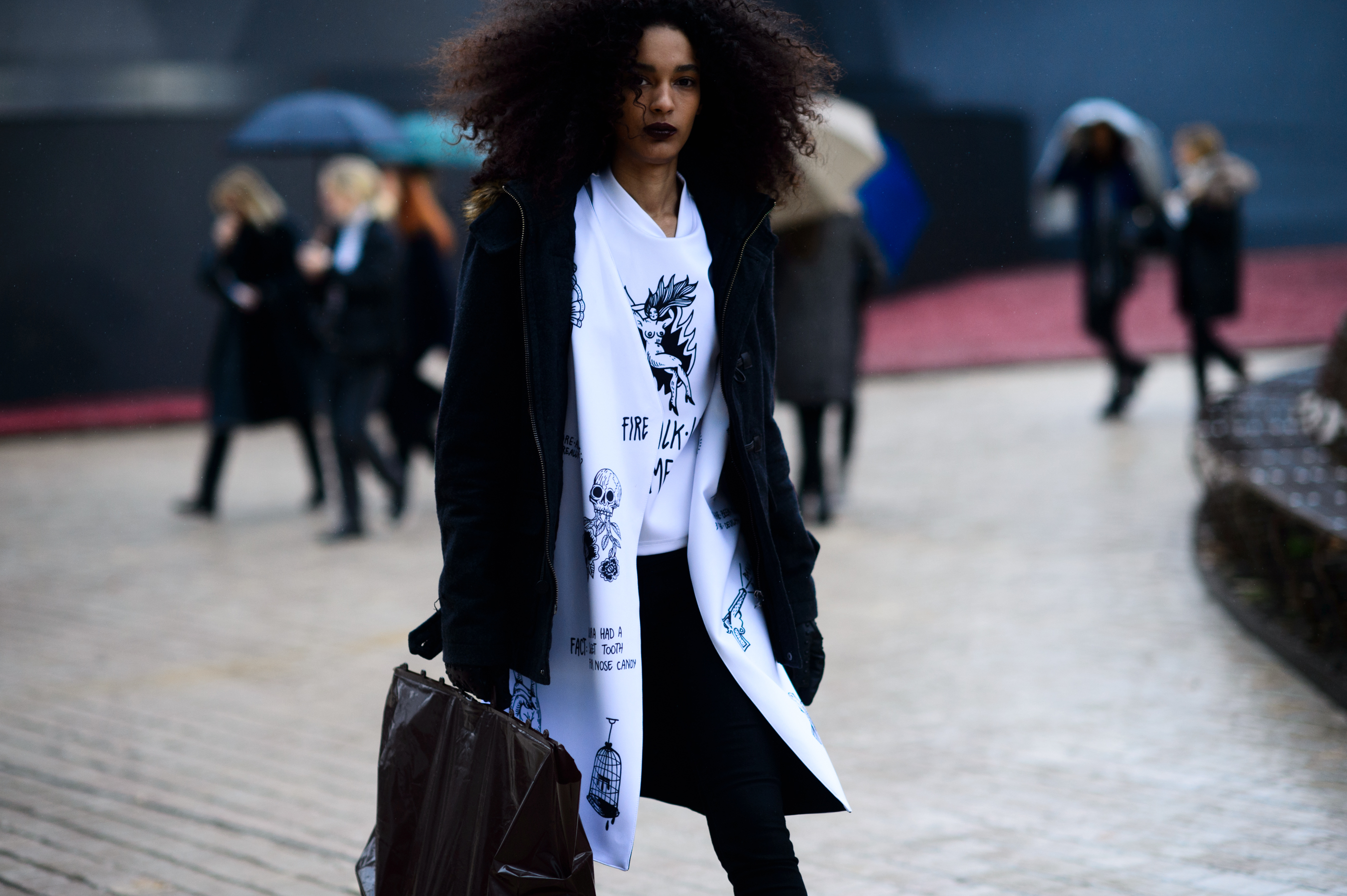 Dominican model wearing white graphic shirt and jacket