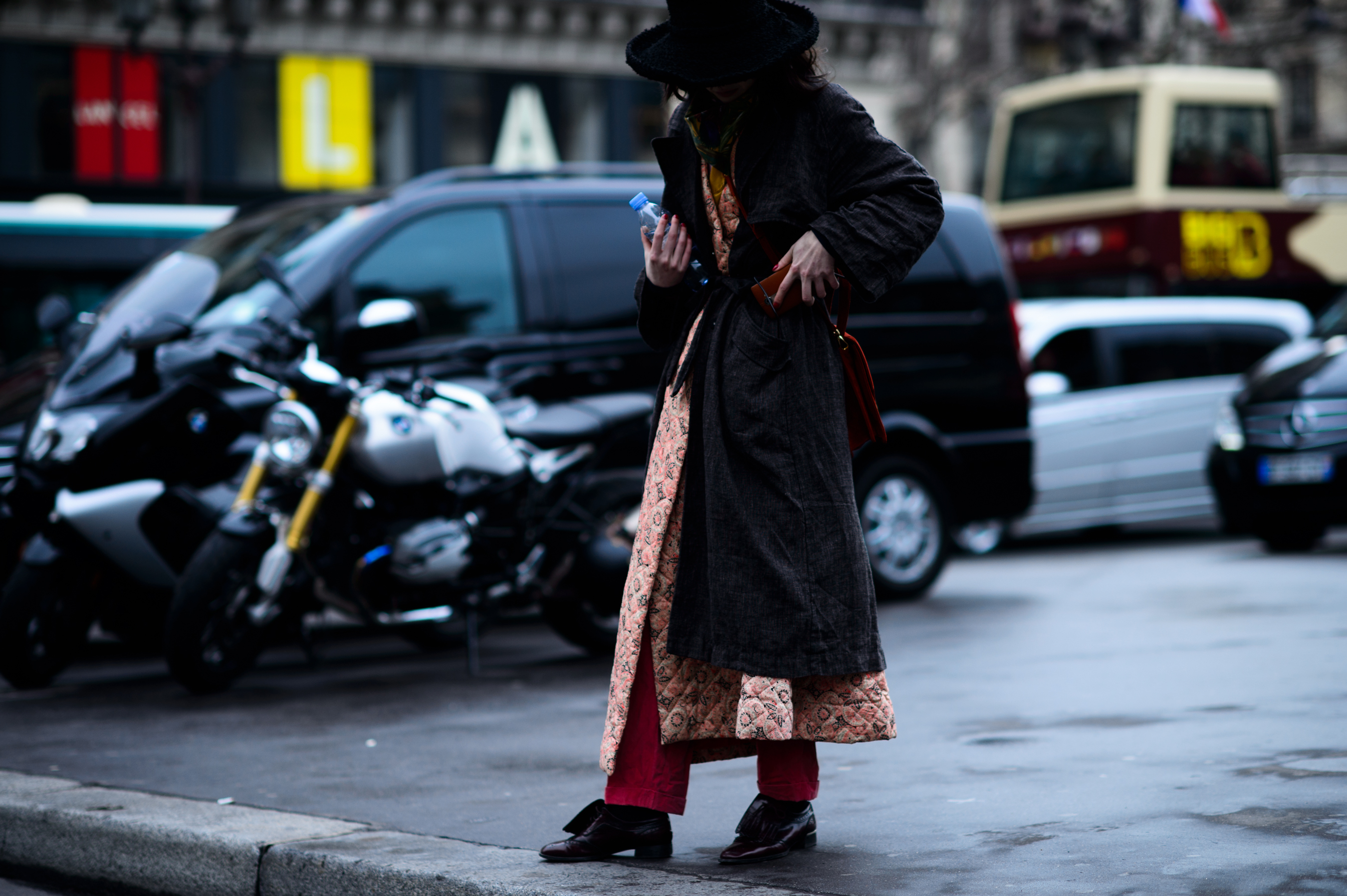 French model wearing long coat and rimmed hat