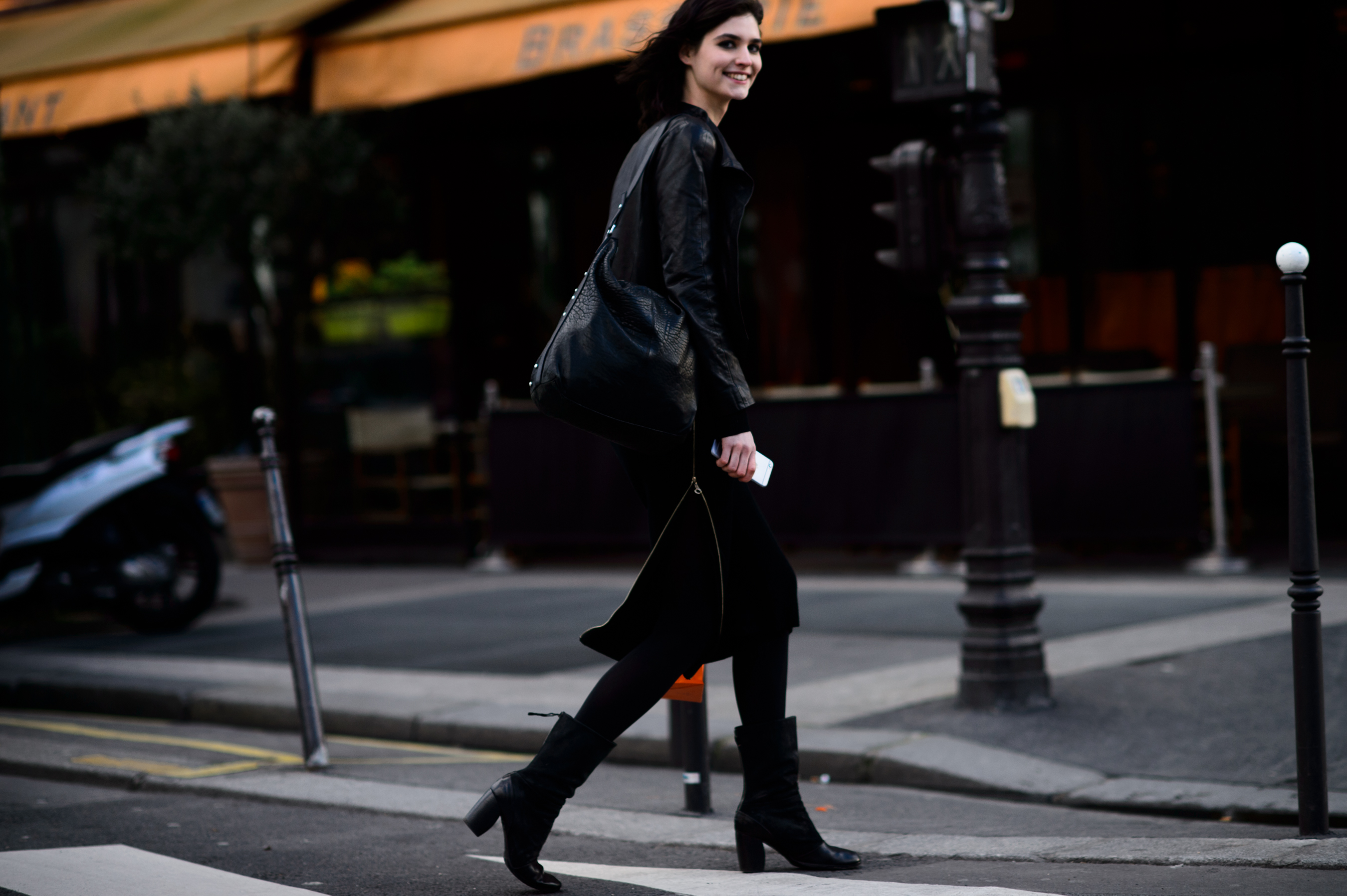 French model smiling over shoulder wearing all black