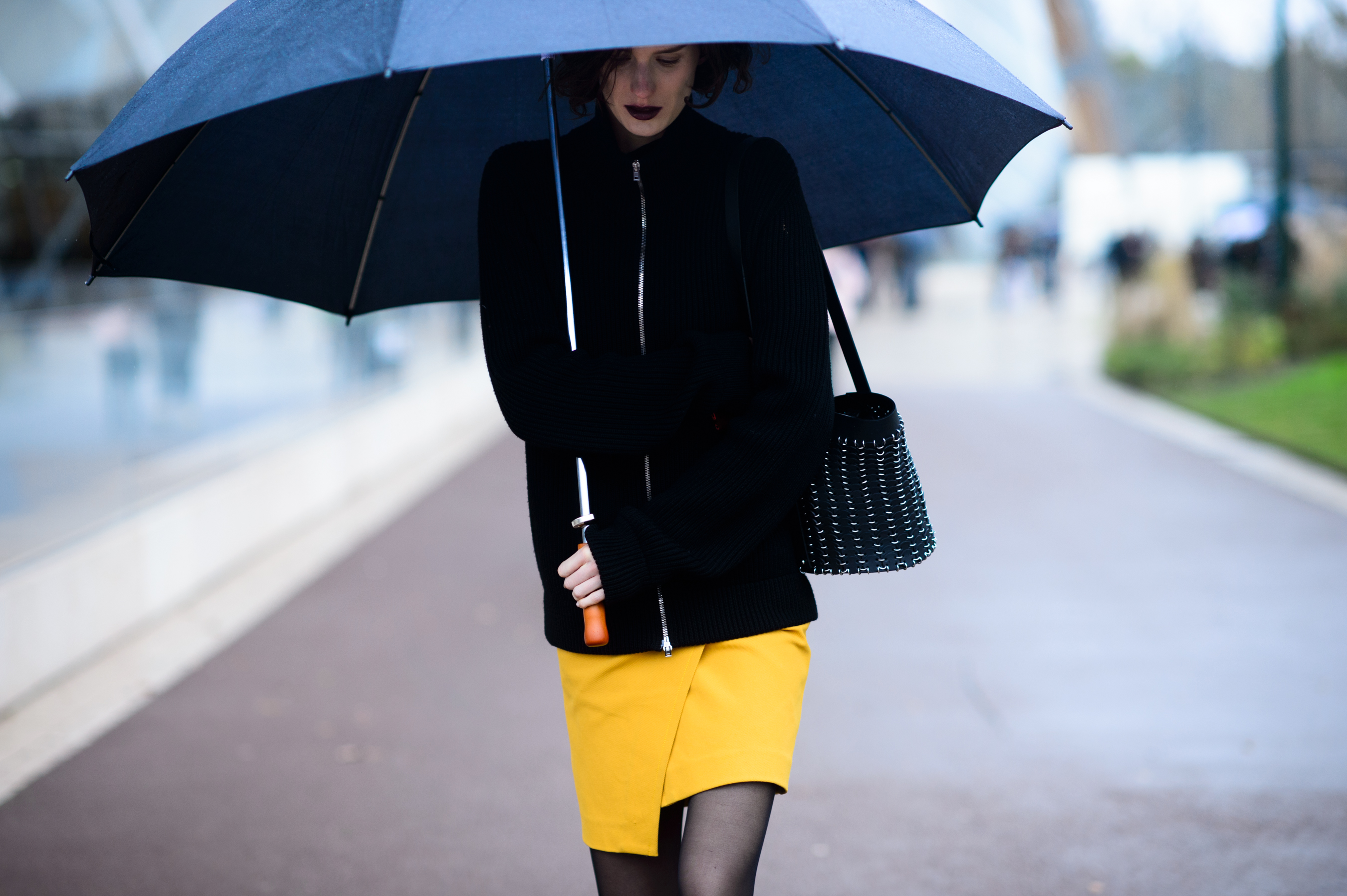 Model under umbrella in yellow skirt