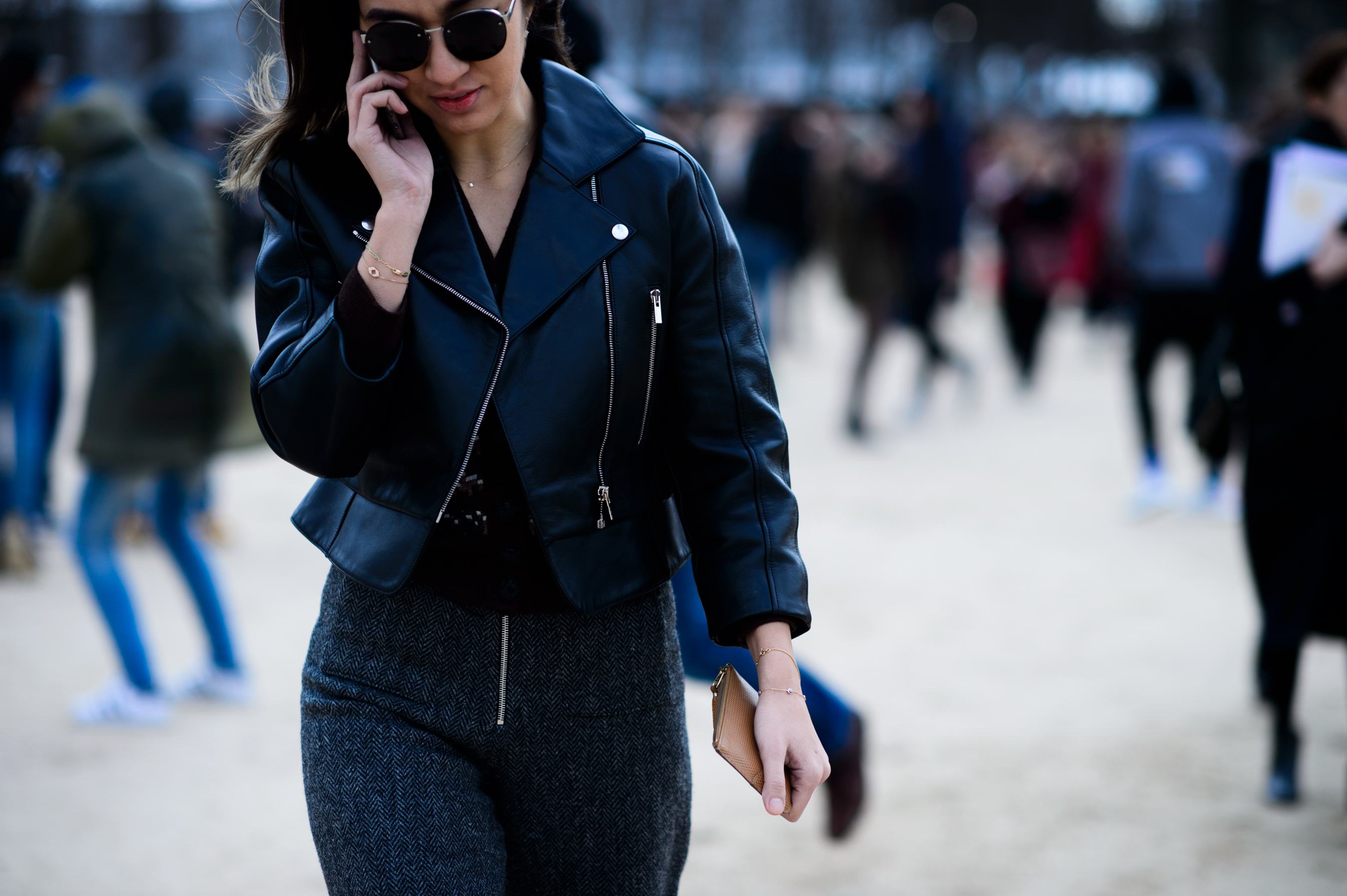 Woman wearing black leather jacket on phone