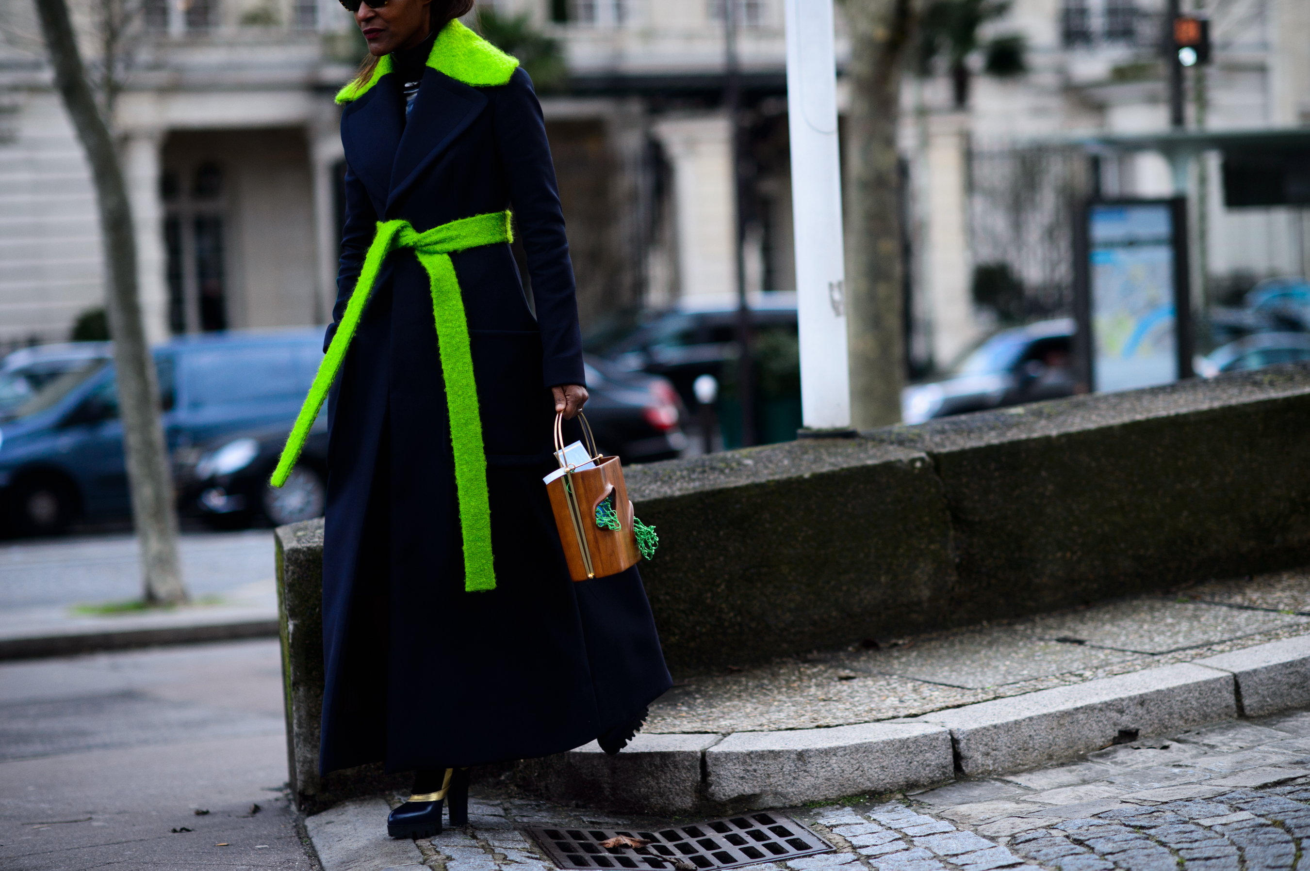 Woman wearing navy and bright green coat