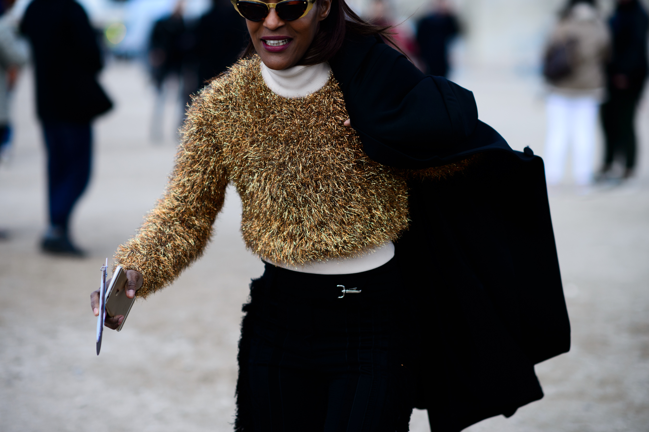 Woman running to show with coat over one shoulder