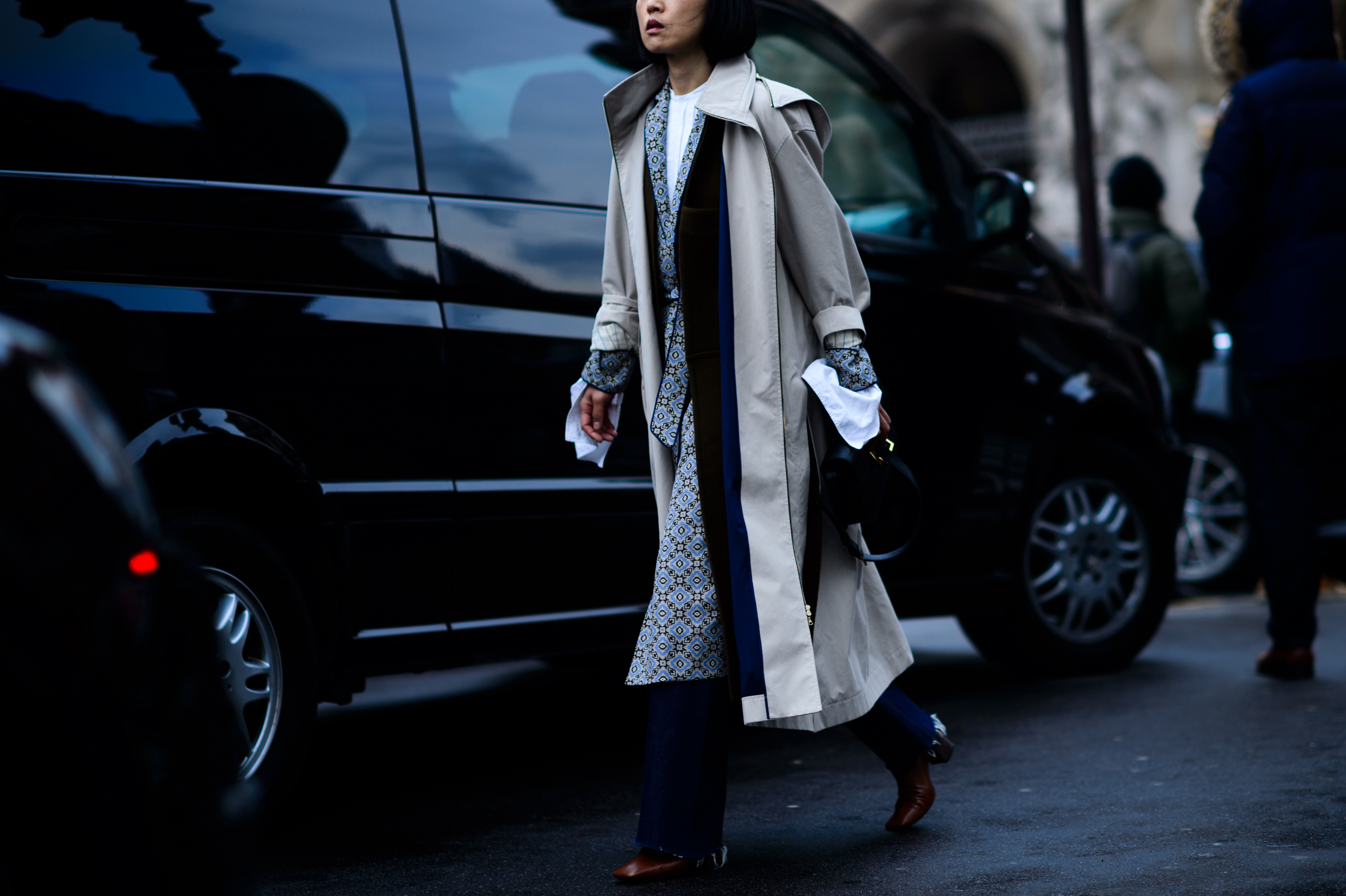 Woman in long draped grey coat