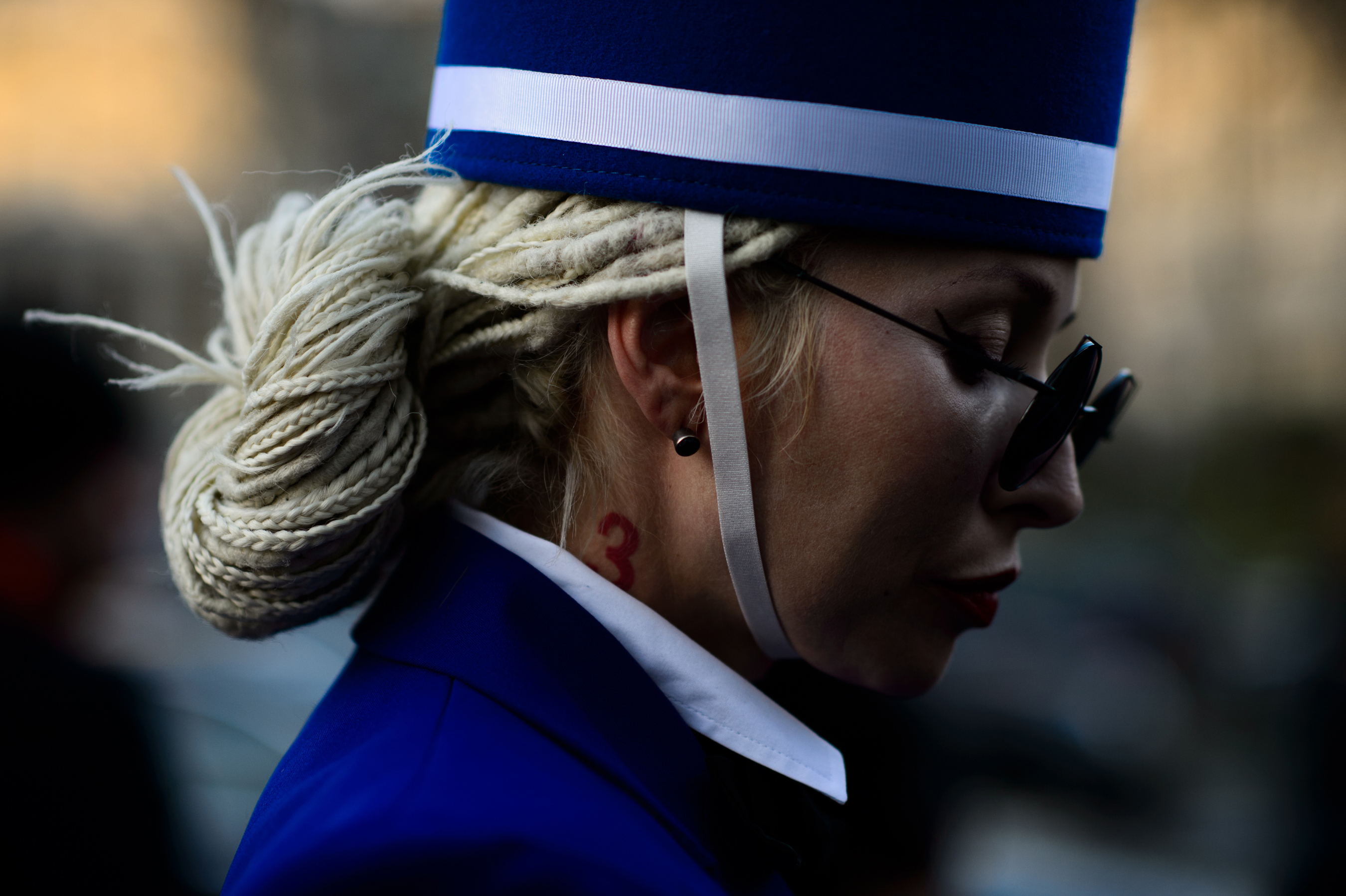 Woman with blonde dreadlocks tied up