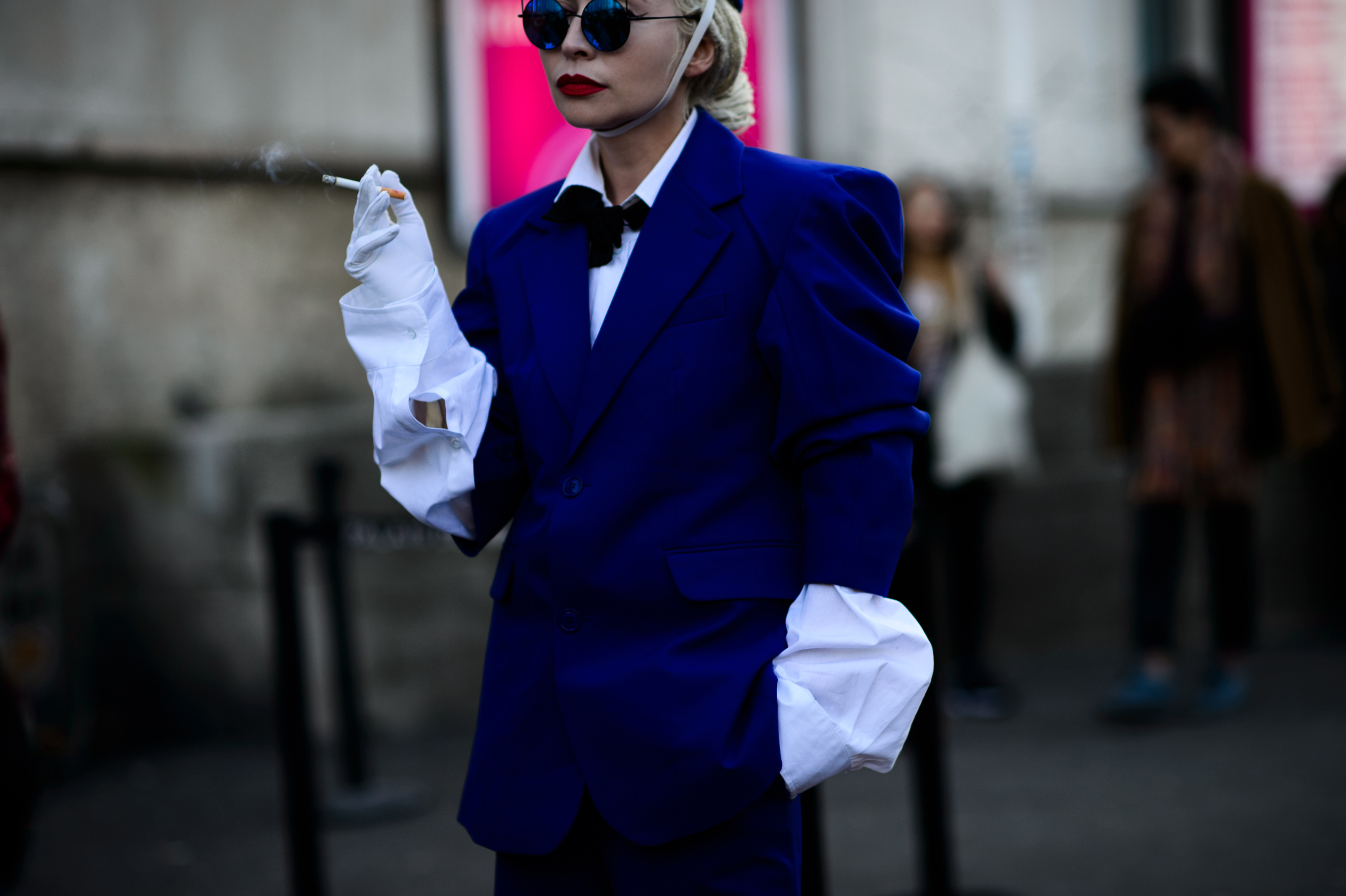 Woman smoking in white gloves