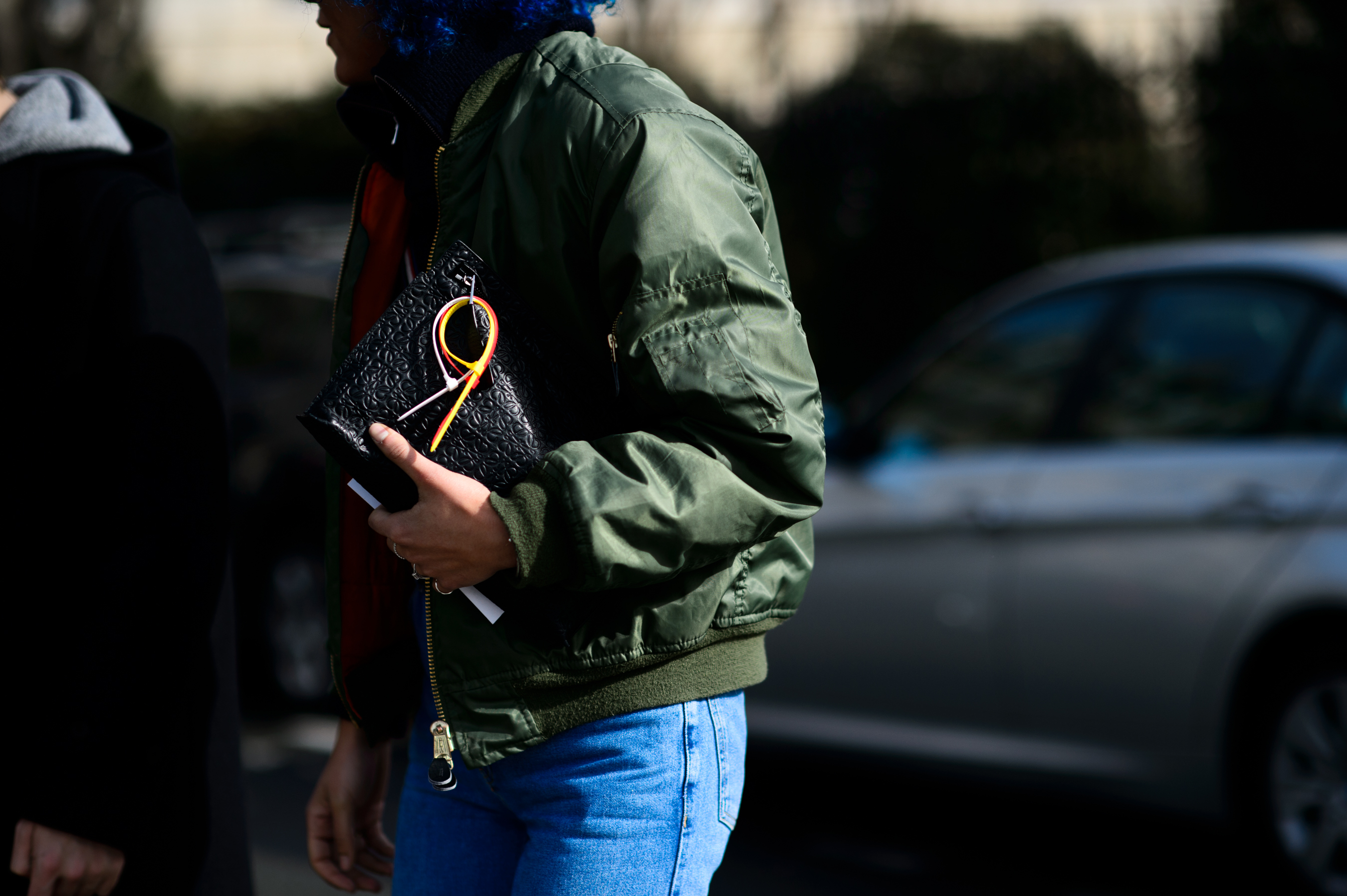 Woman wearing olive bomber jacket