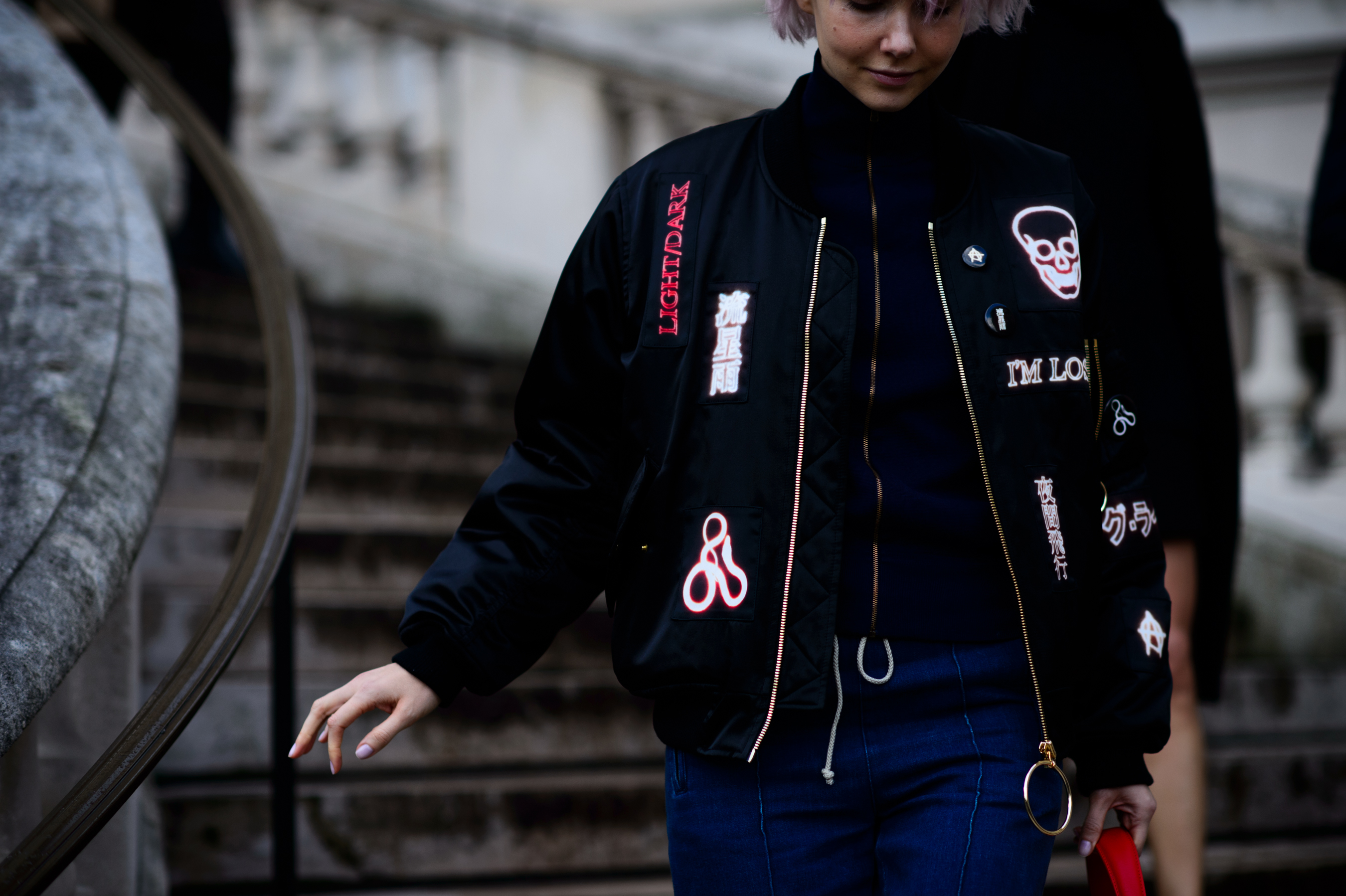 Woman wearing black patched jacket