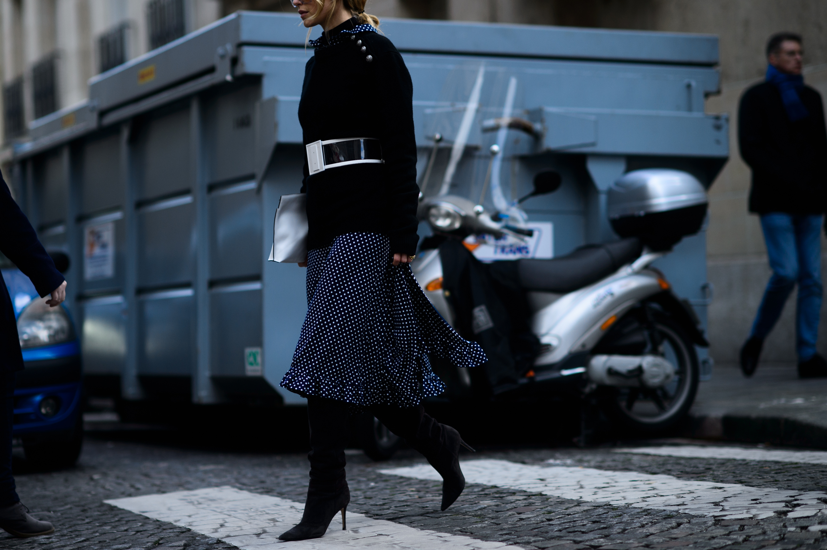 Woman in spotted skirt crossing road
