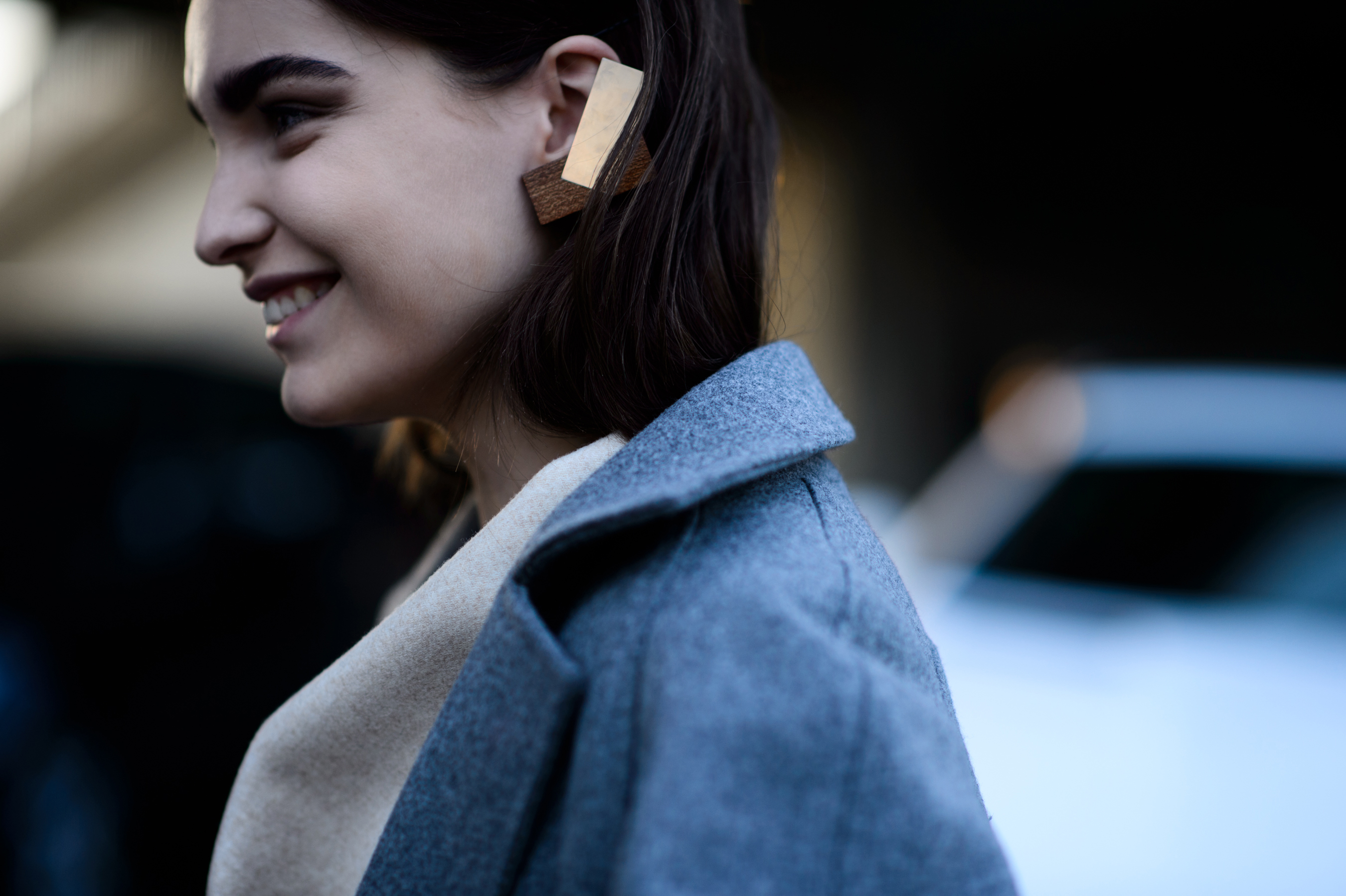 Model wearing wooden ear ring