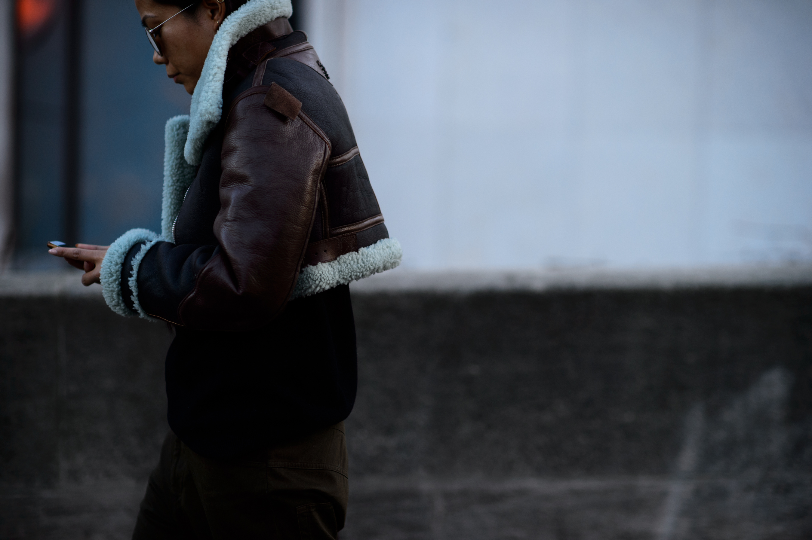 Woman in brown jacket with blue trim