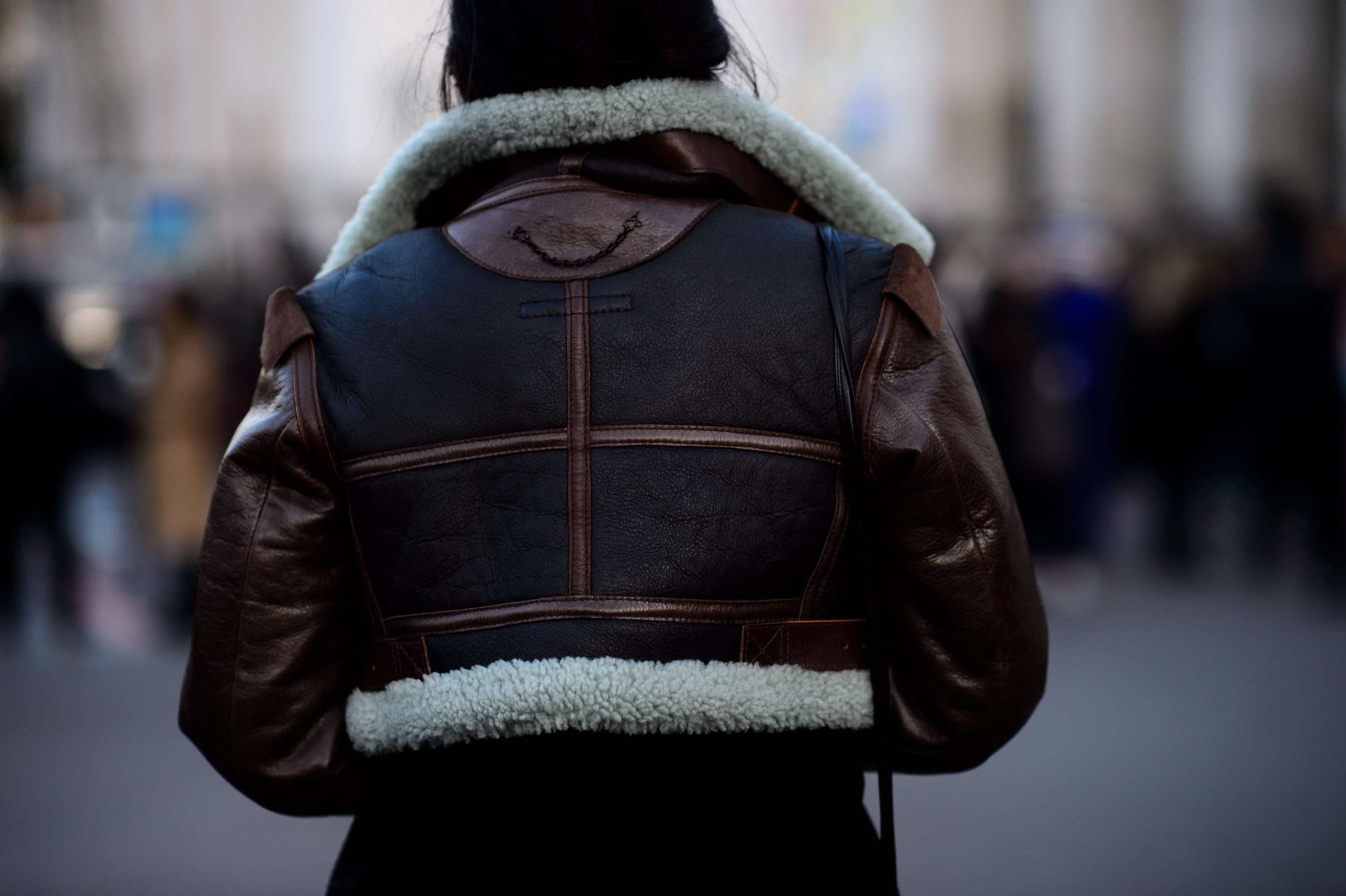 Woman in leather jacket from rear