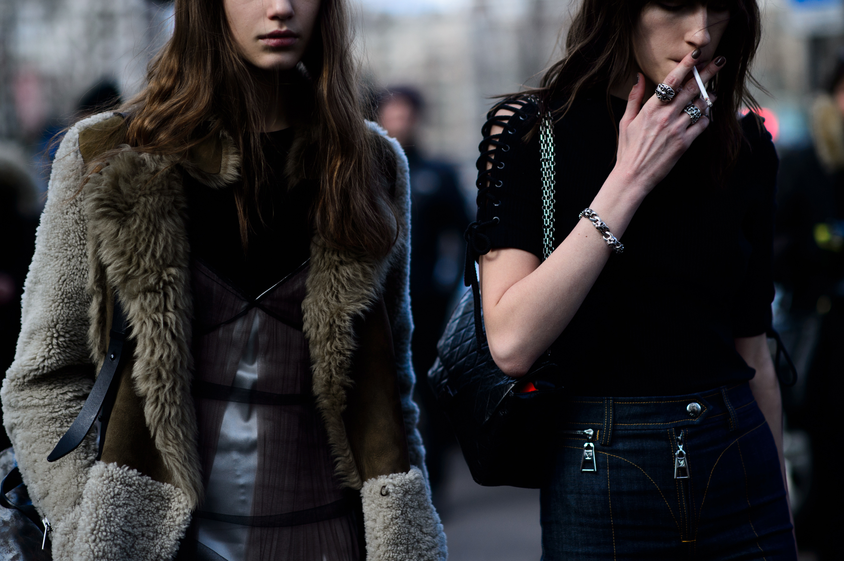 Two models leaving show whilst smoking