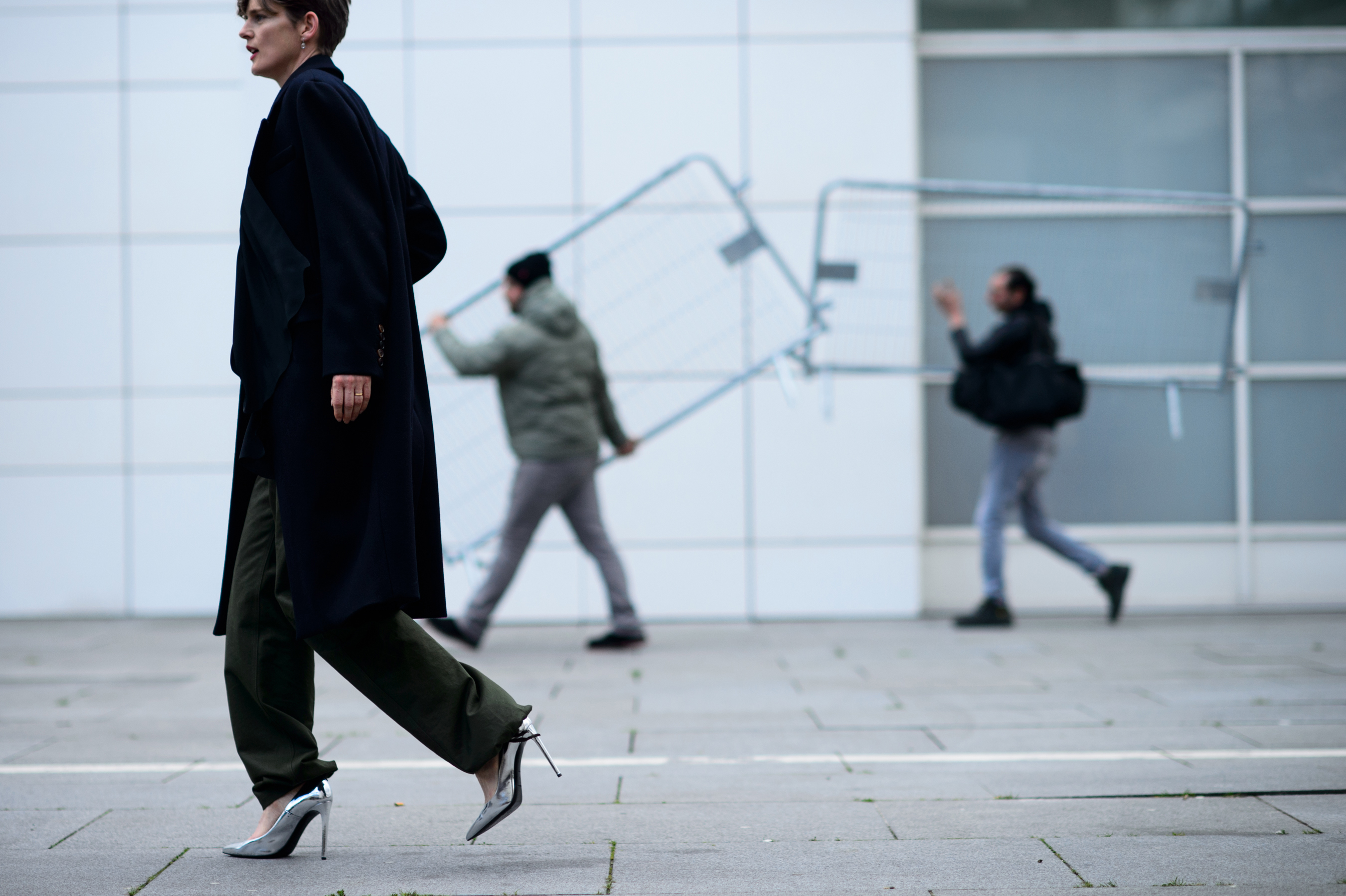 Woman walking in front of construction workers