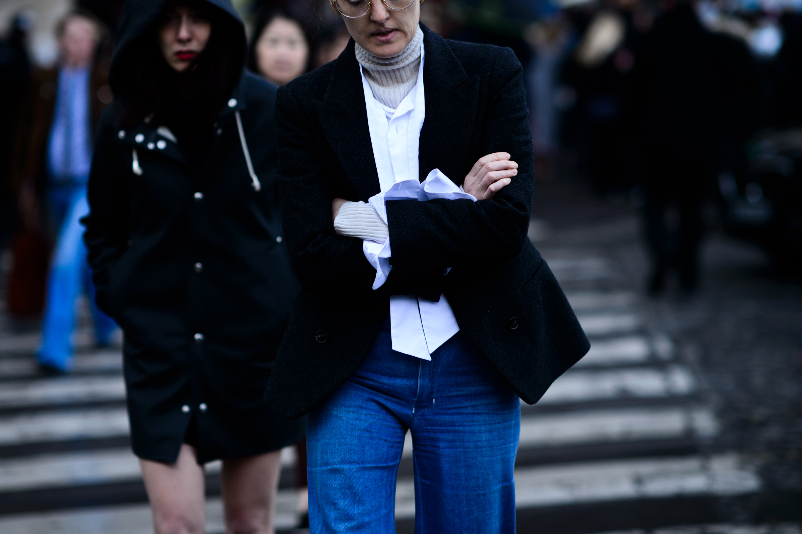 Woman with crossed arms in long sleeve white shirt