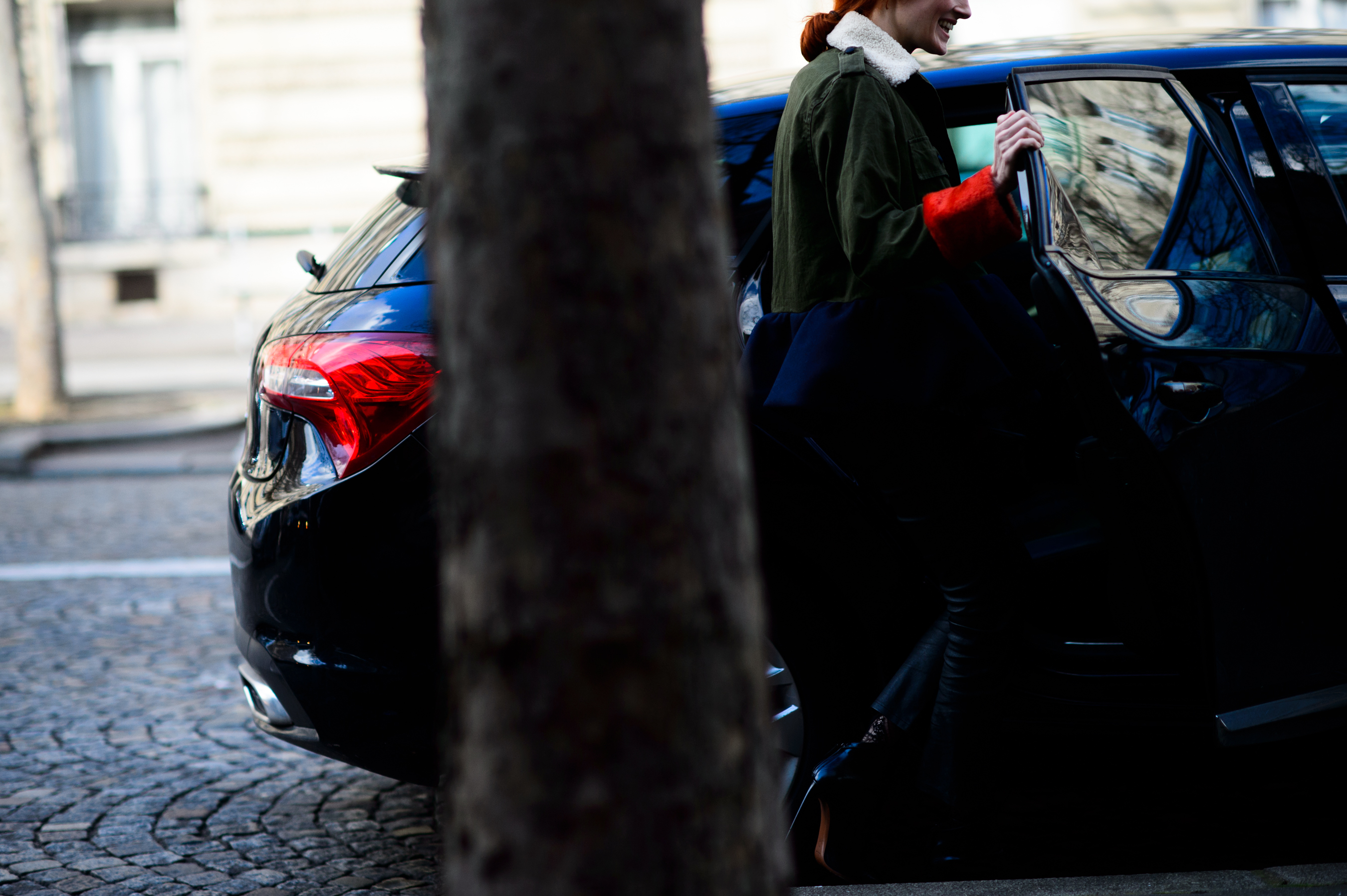Woman in green denim getting in car