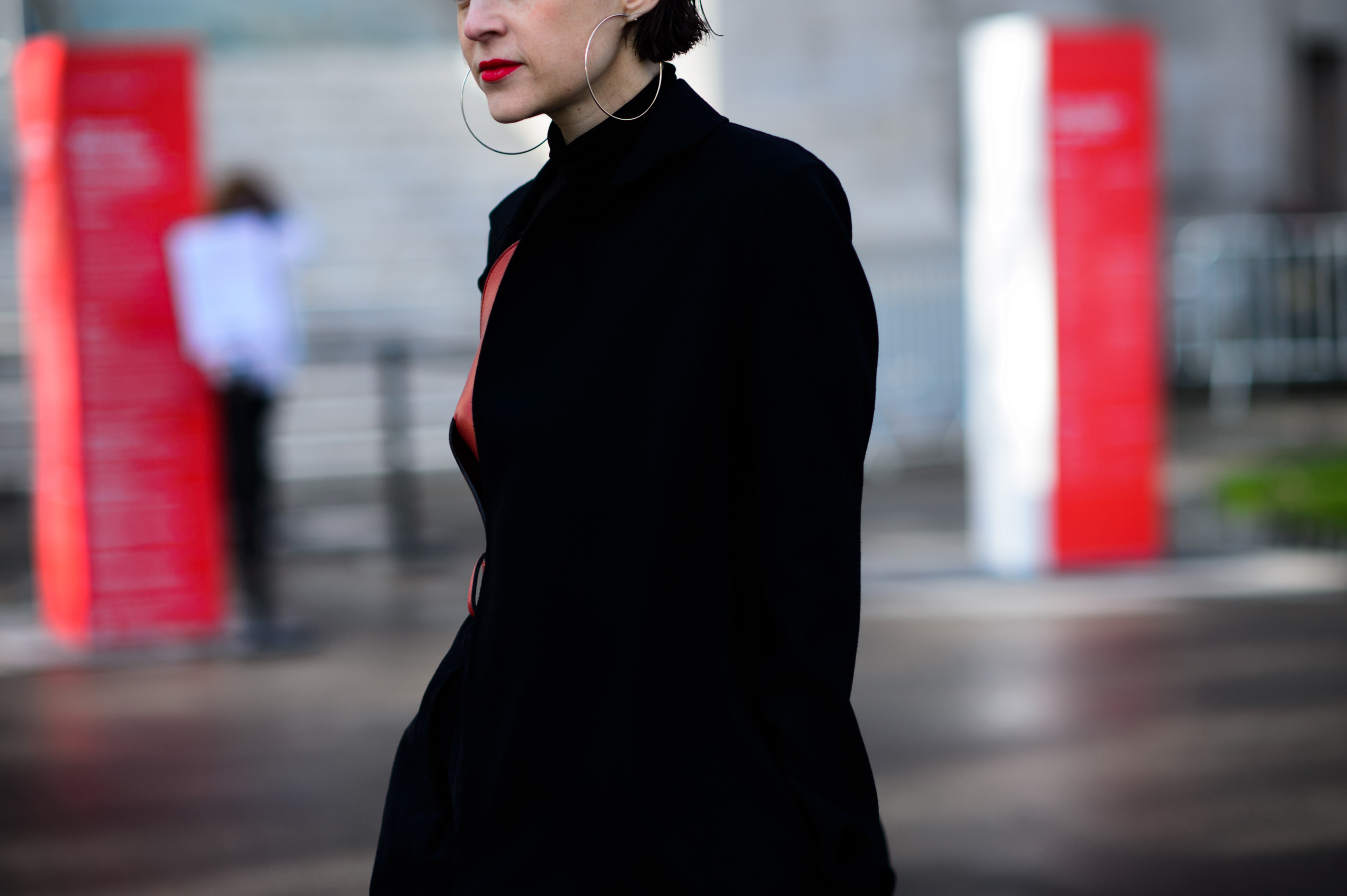 Woman in black dress with hoop earrings
