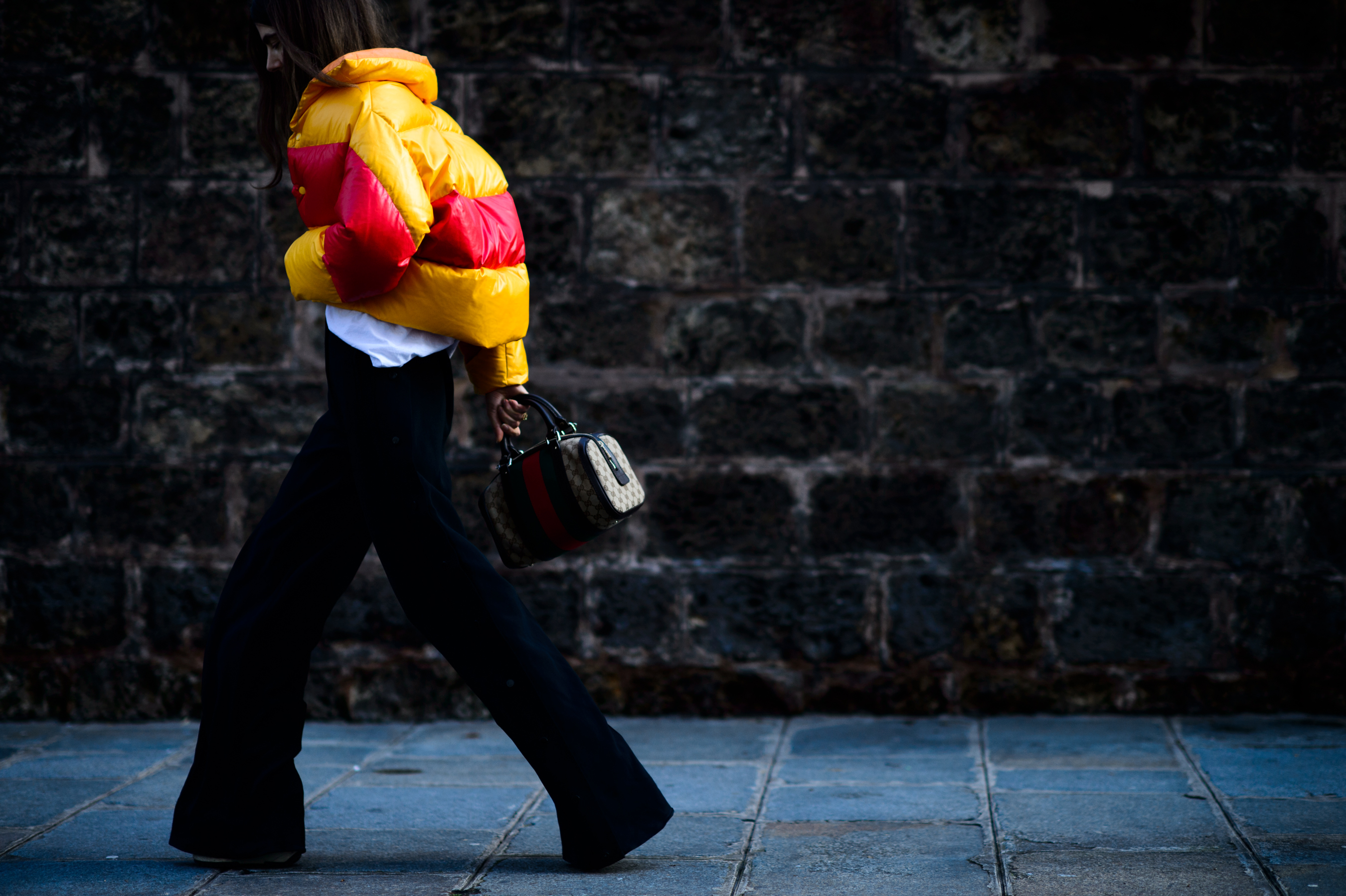 Woman walking in red and orange puffer jacket