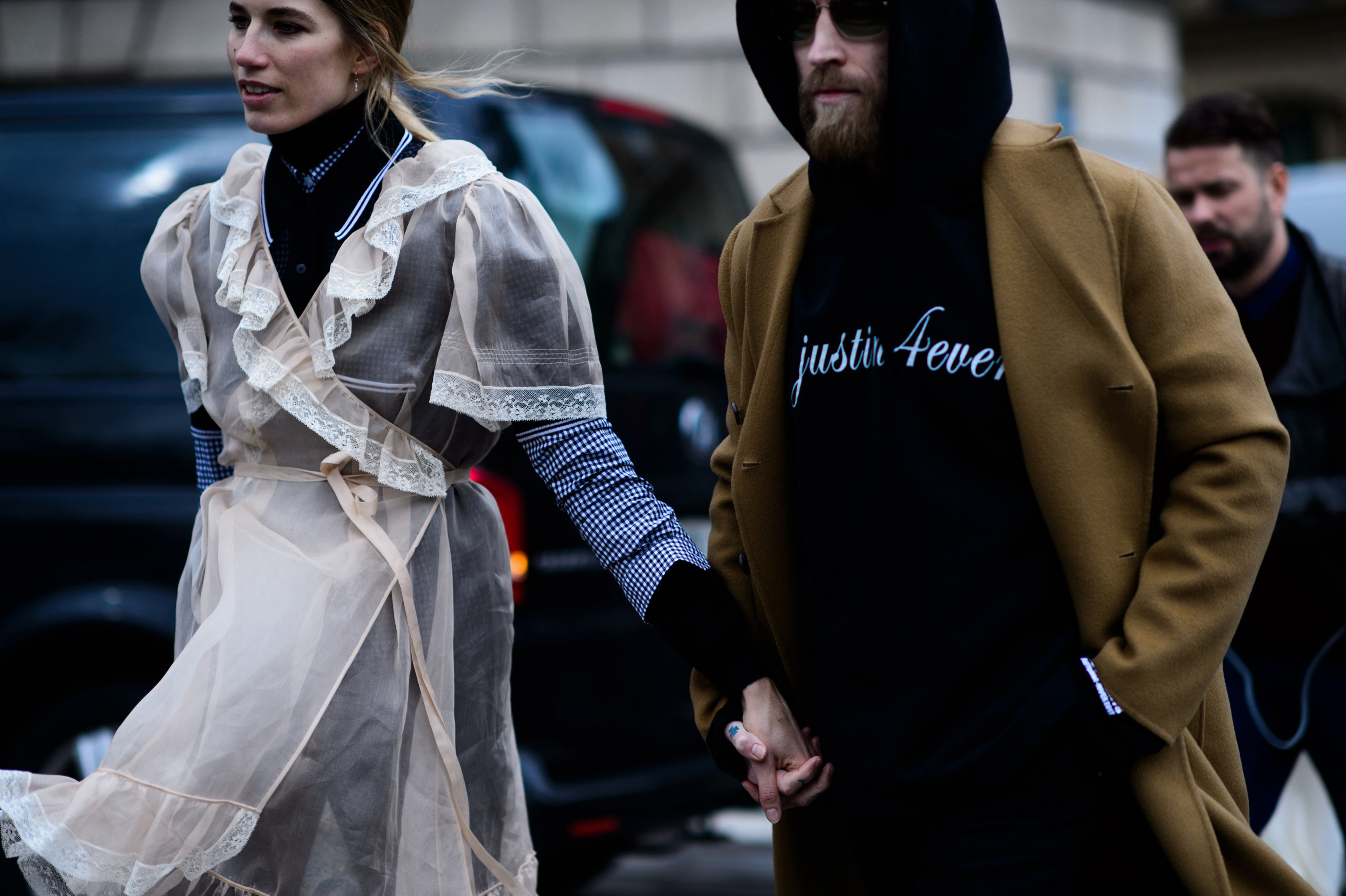 Two buyers holding hands wearing black and lace