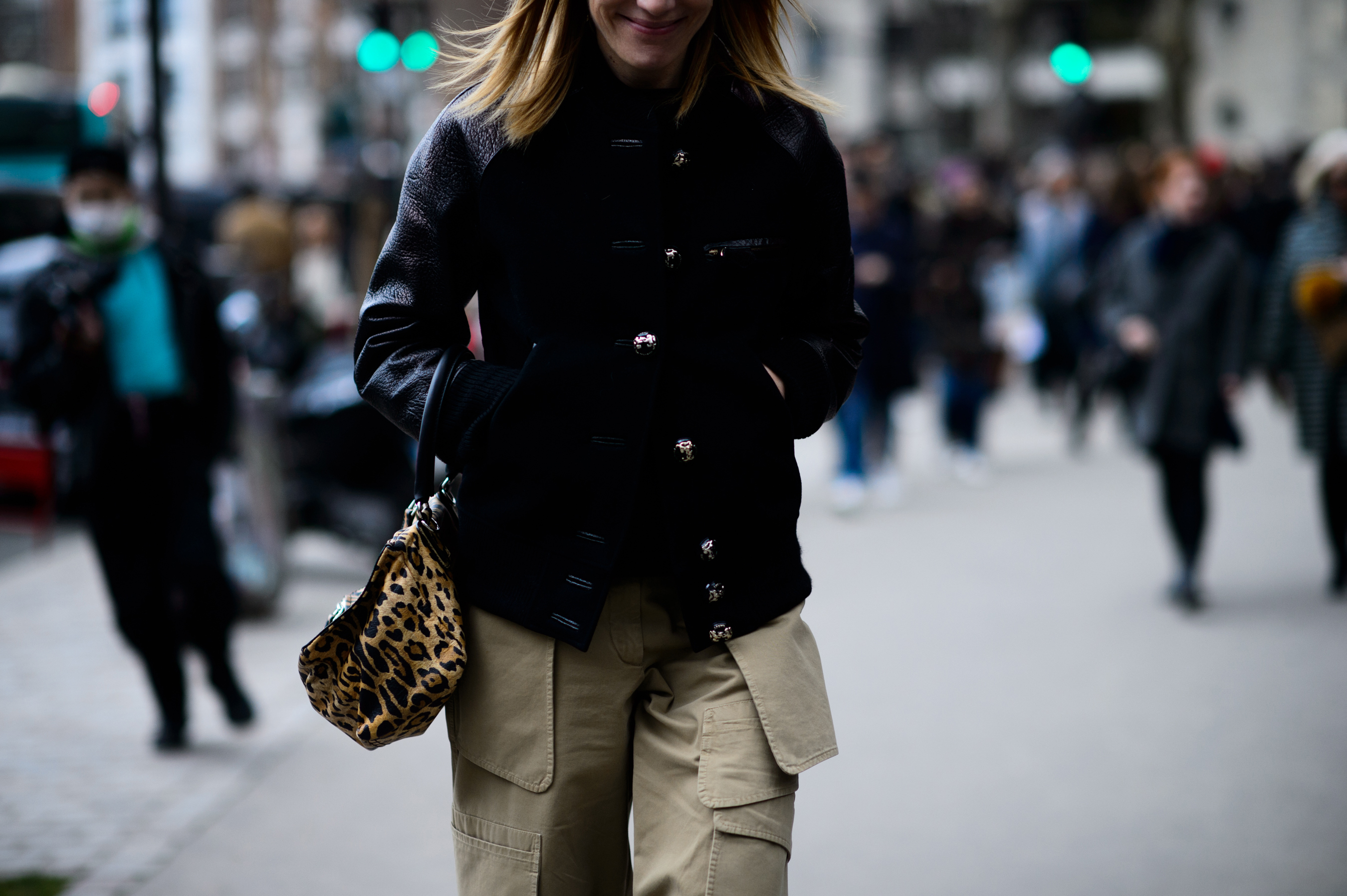 Woman with animal print handbag and black jacket