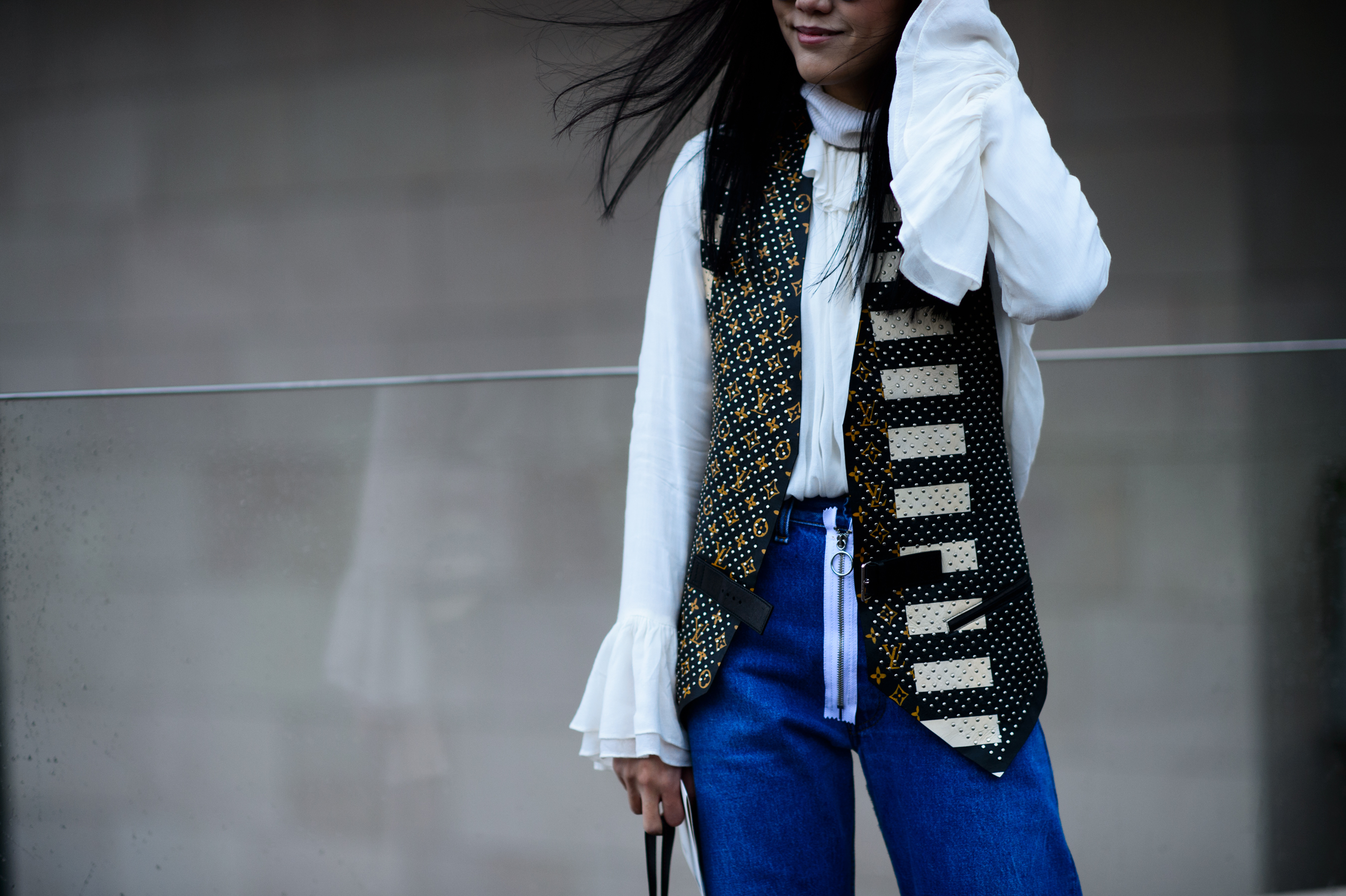 Woman wearing white long sleeve shirt with gold waistcoat