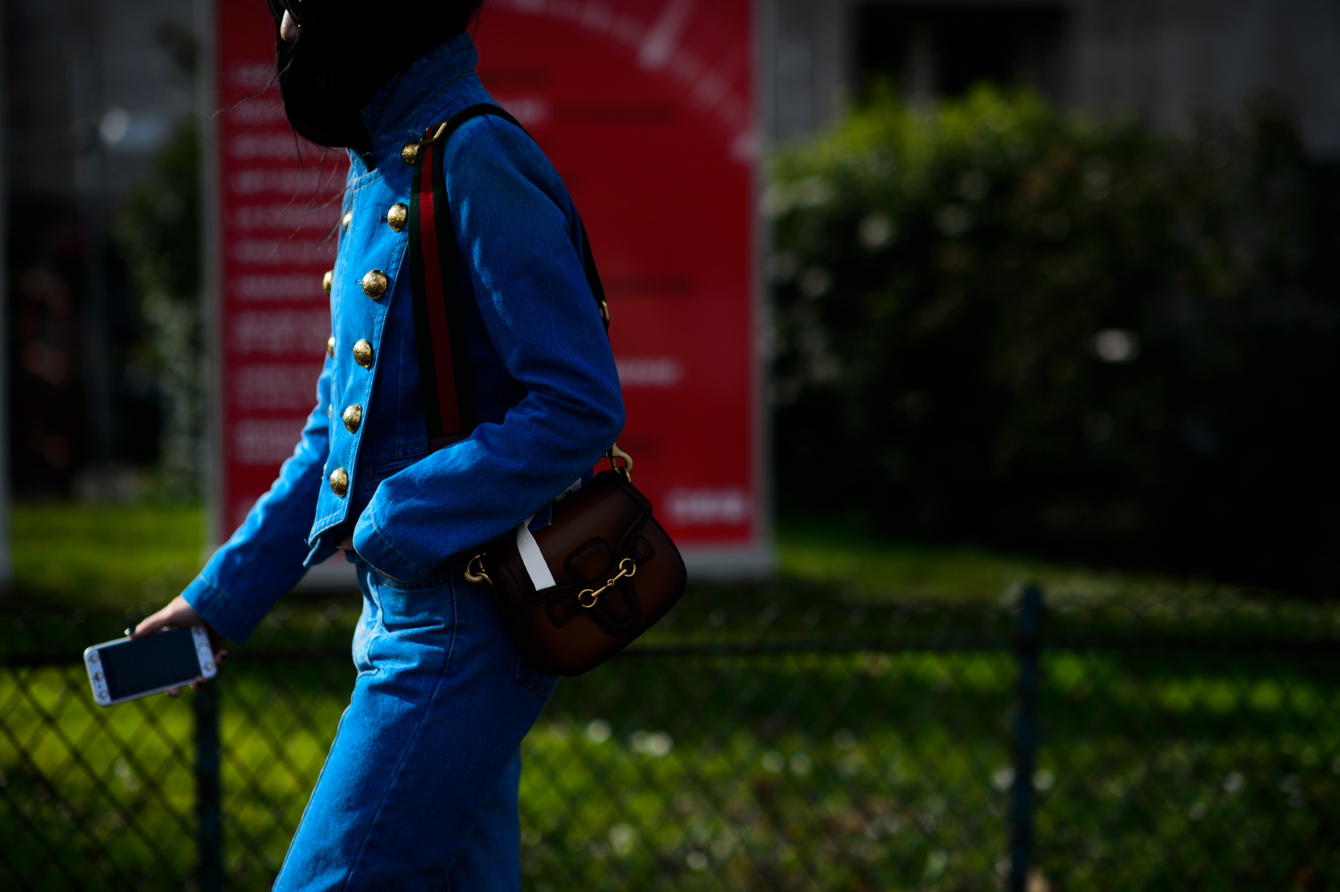 Woman wearing blue denim with gold buttons