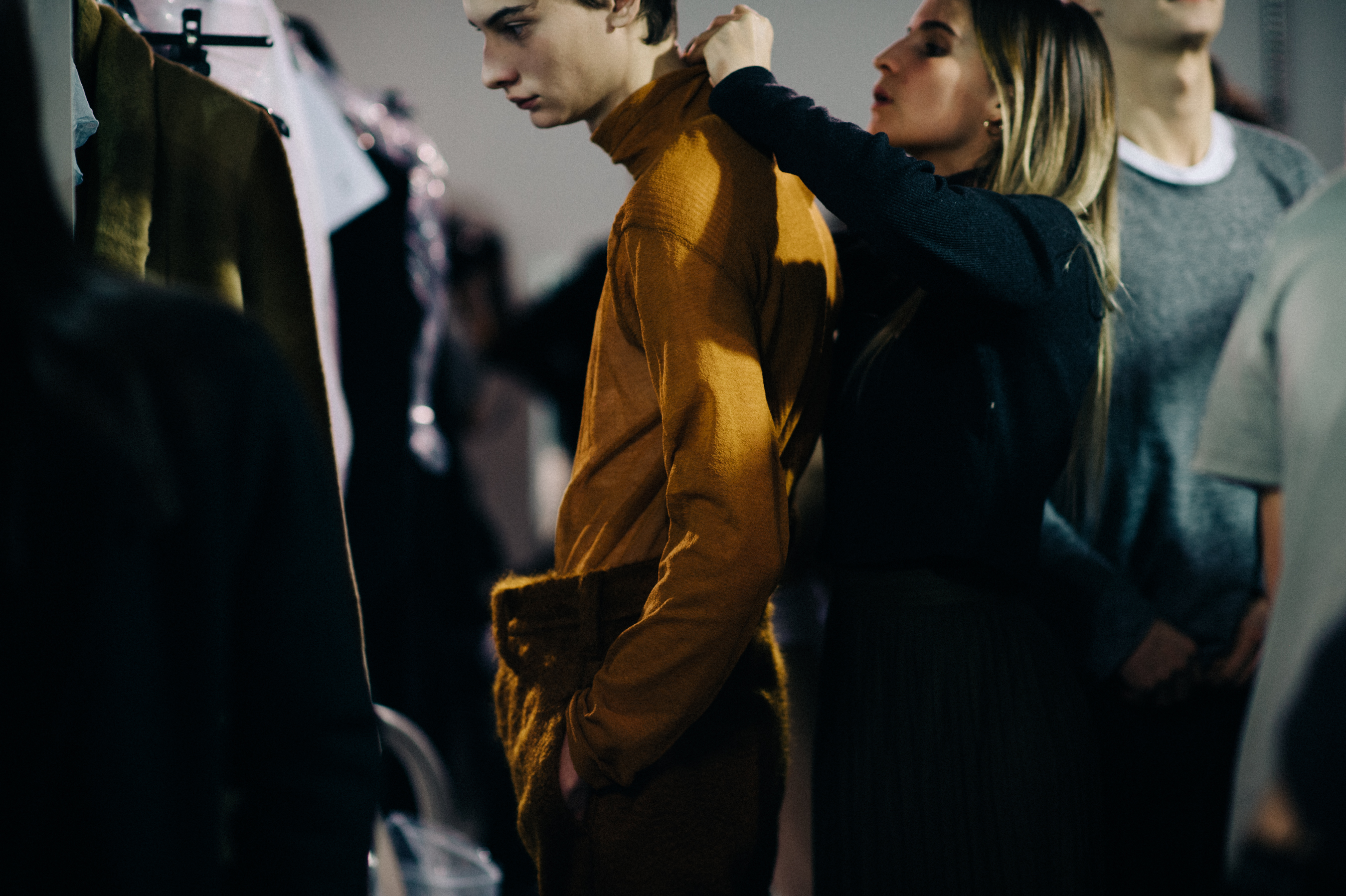 Male model getting dressed before show