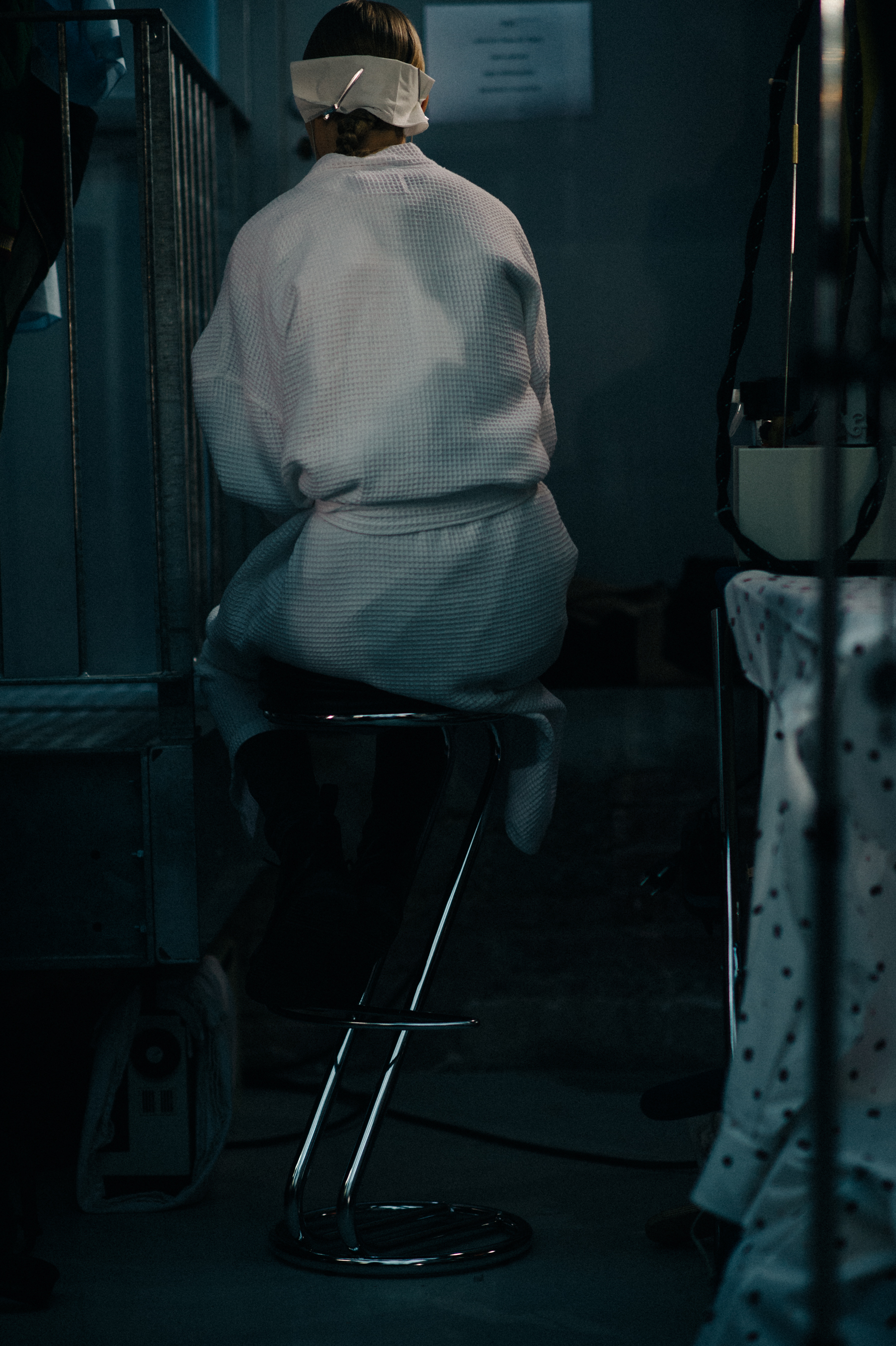 Model on chair wearing white robe