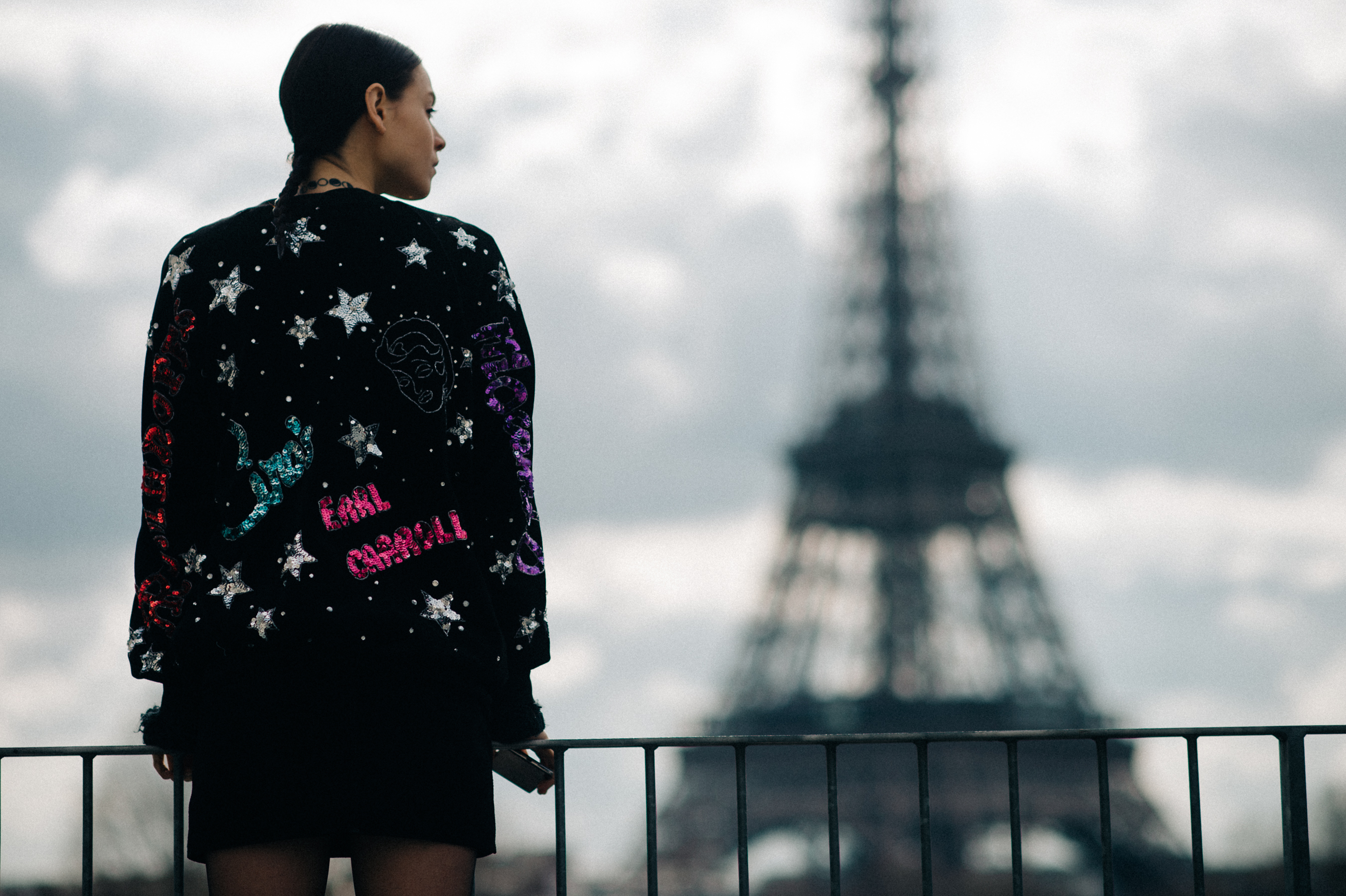 Model standing next to Eiffel tower