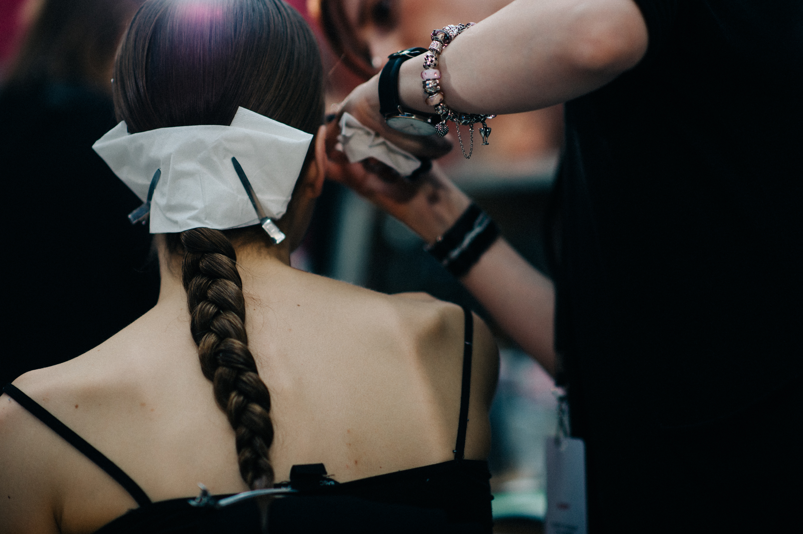 Model with braid getting makeup